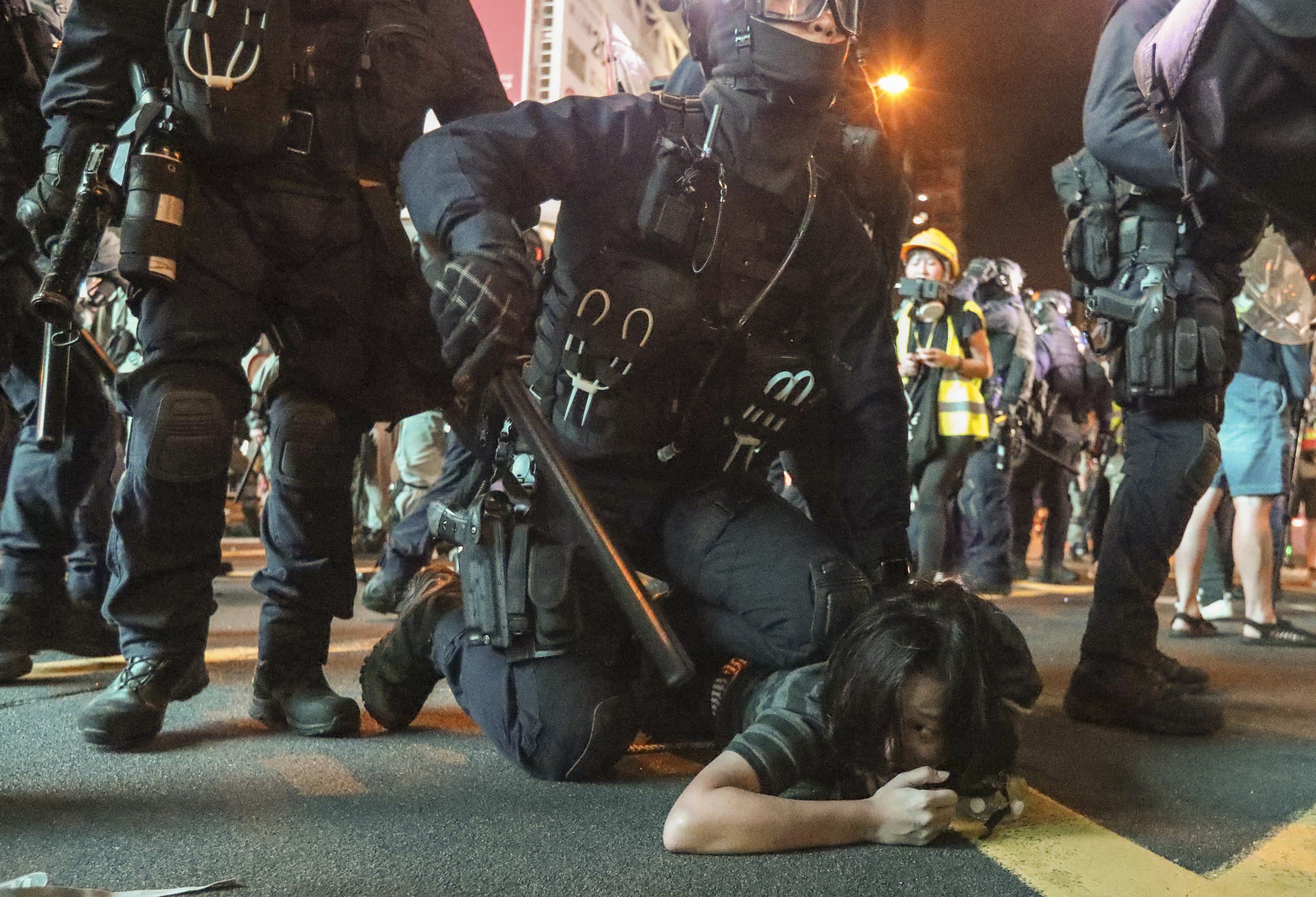 A riot police officer pins a protester to the ground during unrest in Mong Kok. Photo: Felix Wong