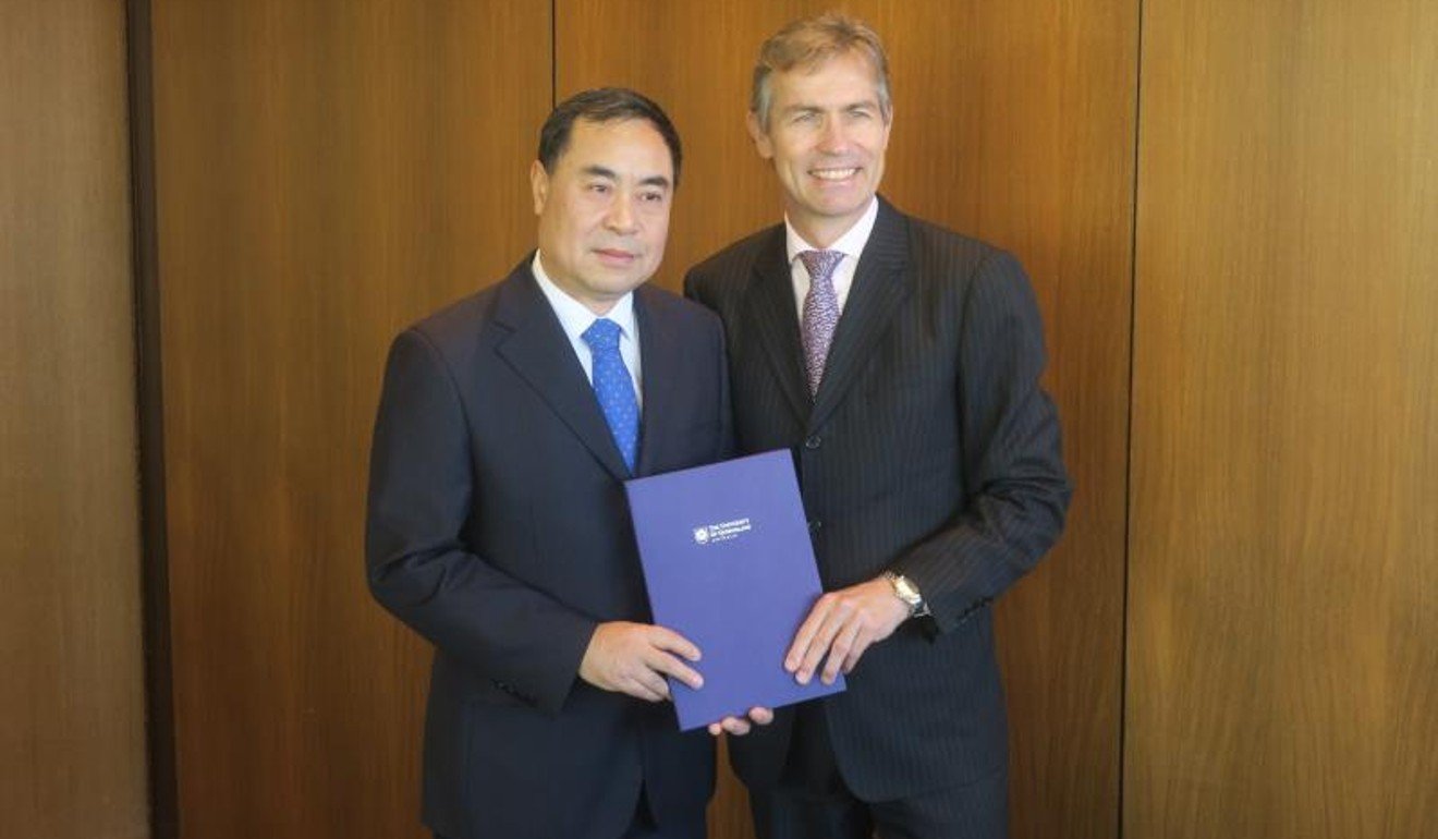Xu Jie (left), the Chinese consul general in Brisbane, is presented with a letter of appointment by University of Queensland president Peter Hoj. Photo: Chinese consulate in Brisbane