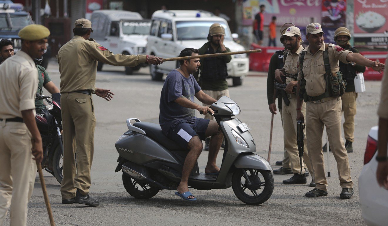 Indian police check the identity of commuters in Jammu, part of Indian-administered Kashmir, on Tuesday. Photo: AP