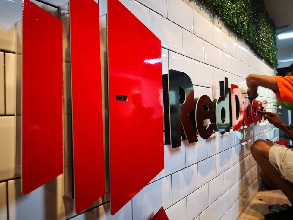 A signage of Singapore-based start-up RedDoorz is set up at one of its properties in Southeast Asia. Image: SCMP/Facebook