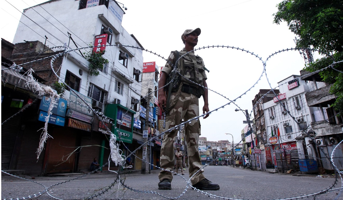 An paramilitary soldier stands guard on a street in Indian-administered Kashmir on Tuesday. Photo: AFP