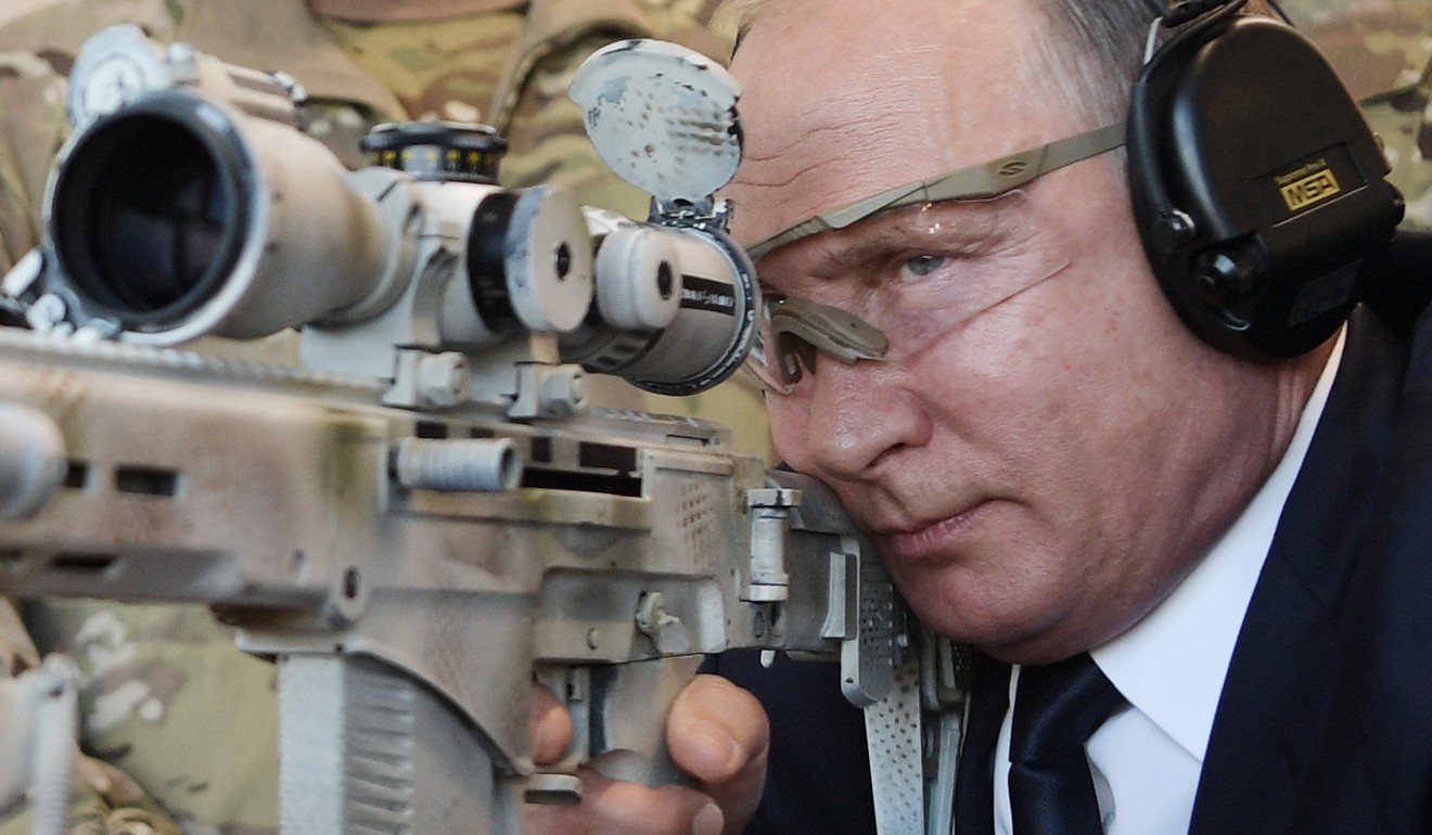 Russian President Vladimir Putin looks through the scope as he shoots a Chukavin sniper rifle. File photo: AFP