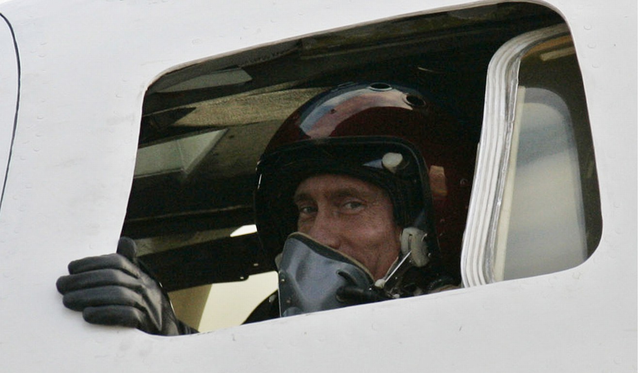 Russian President Vladimir Putin poses for a picture inside a Tupolev-160 strategic bomber jet in 2005. File photo: AFP