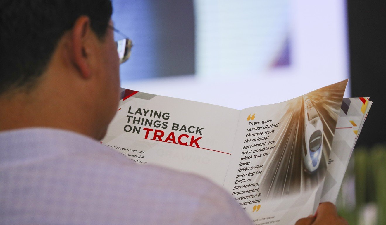 China's Ambassador to Malaysia, Bai Tian, looks at a booklet during the relaunch of the ECRL project in July. Photo: EPA