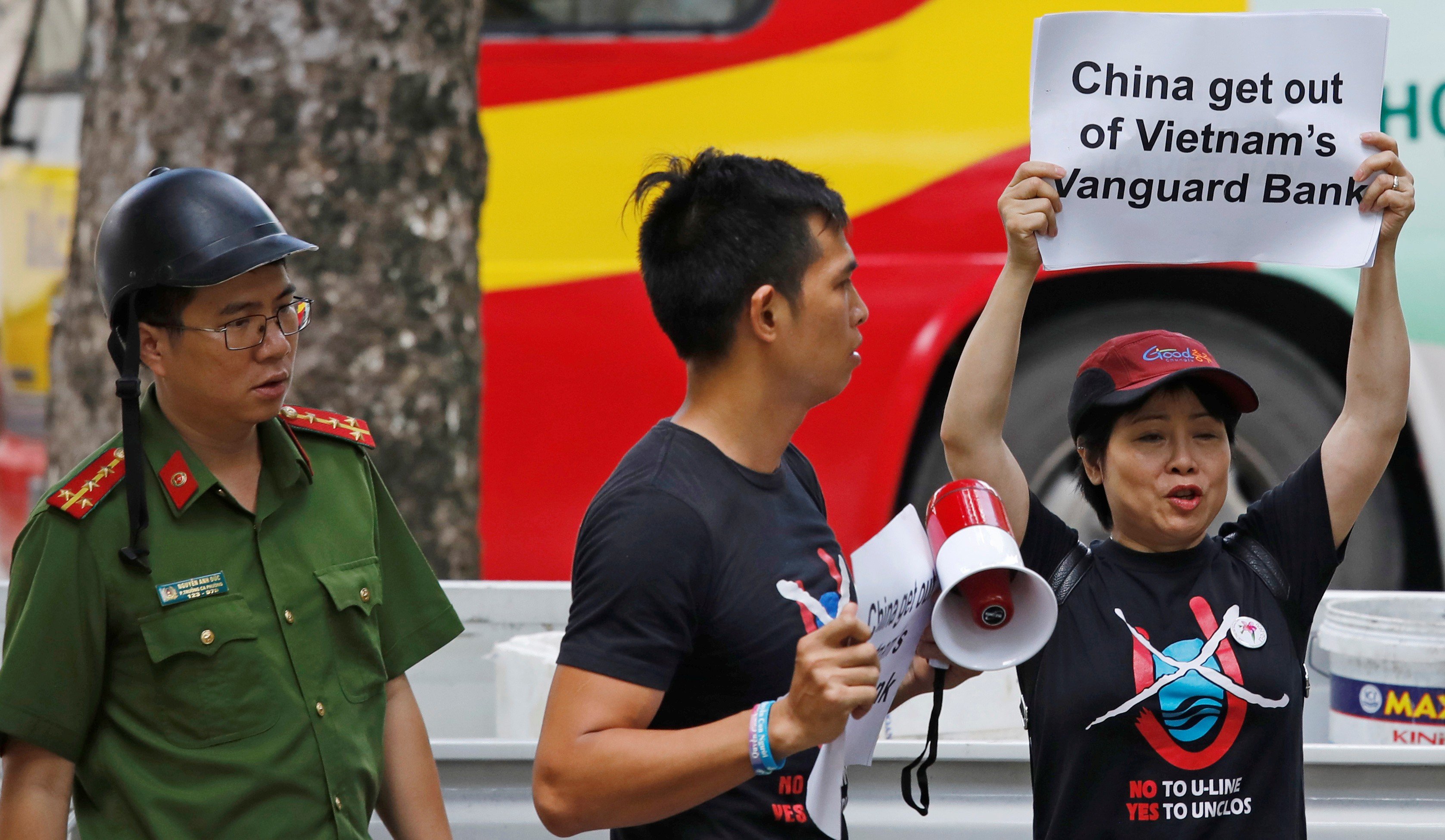 A Vietnamese policeman approaches anti-China protesters demonstrating against Beijing’s actions in the Vanguard Bank stand-off. Photo: Reuters