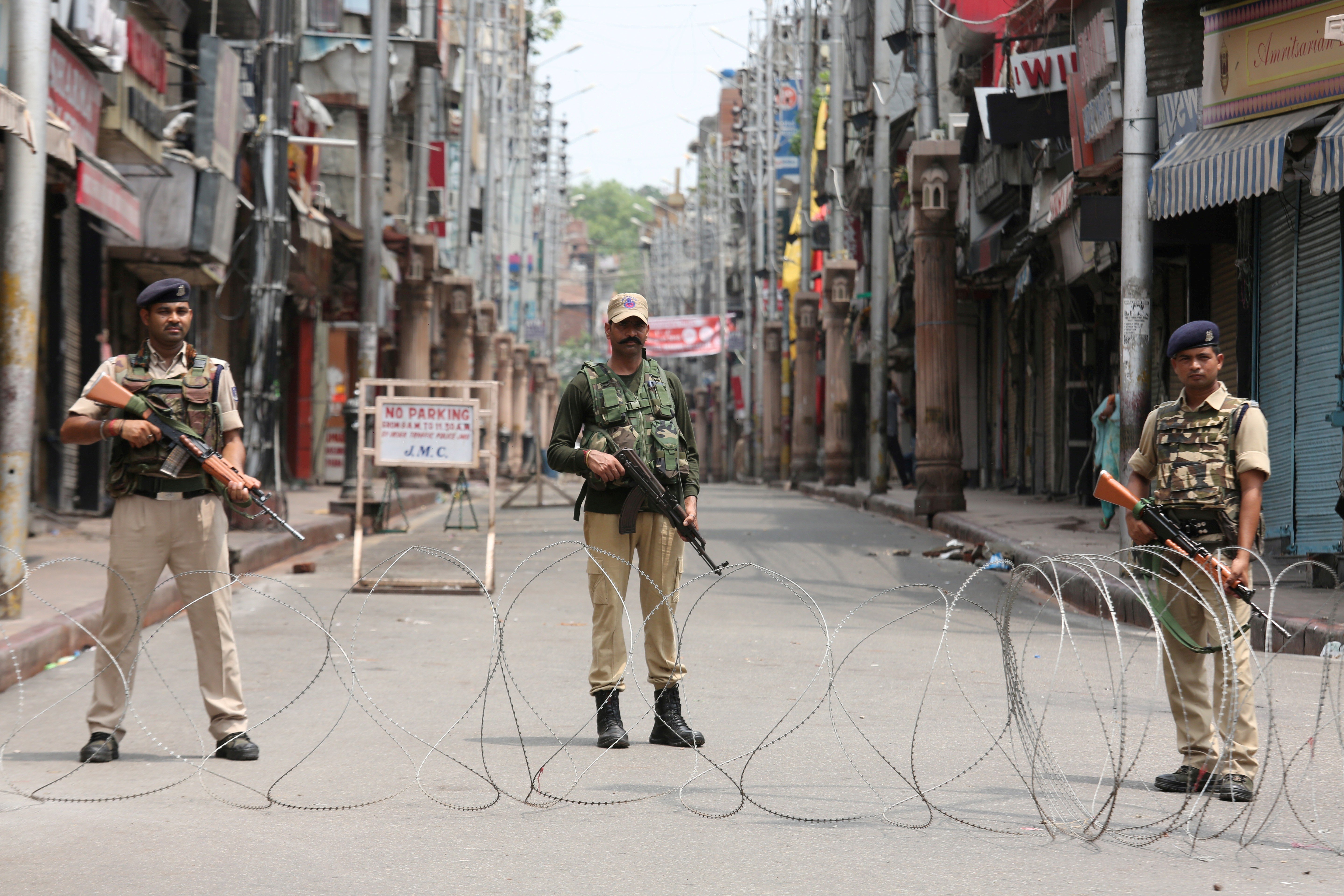 Indian security personnel stand guard on a deserted street in Jammu on Monday. Photo: Reuters