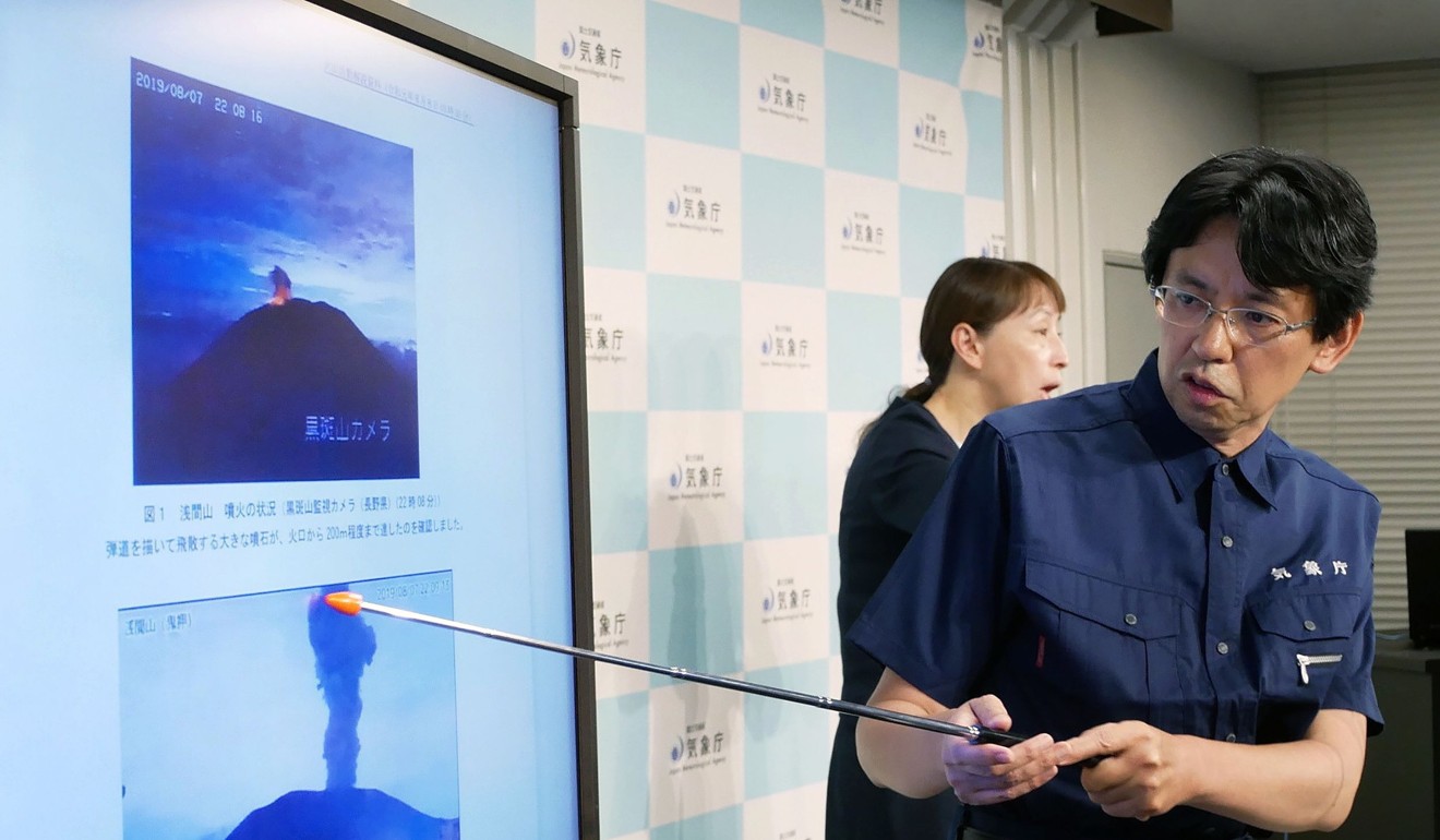 An expert at Japan's Meteorological Agency volcanological division speaks about the eruption of Mount Asama. Photo: AFP