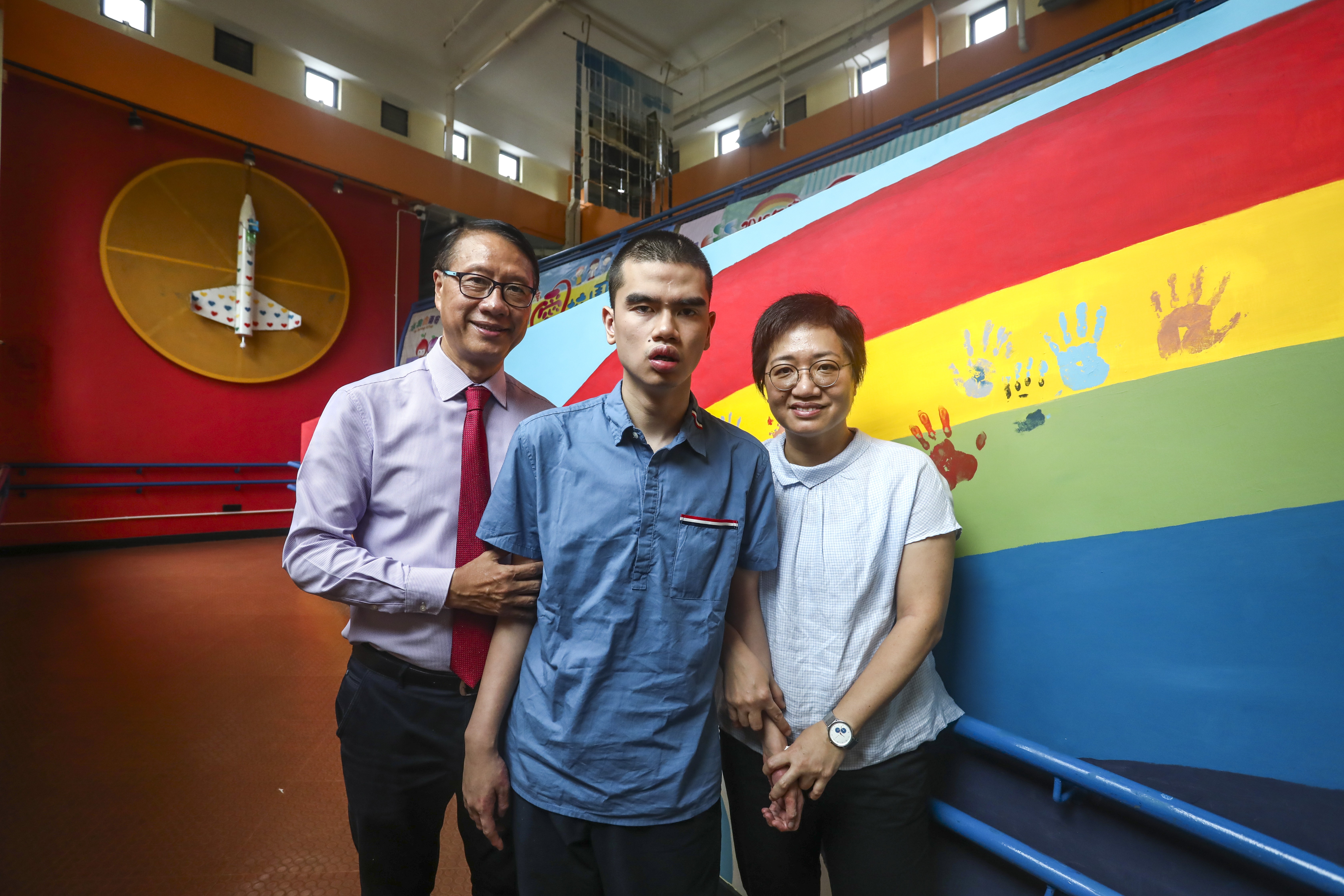 (From left) Billy Law, superintendent of Haven of Hope Sunnyside Enabling Centre (Tseung Kwan O), Heihei Tsang; and his mum Renee Lai. Photo: Jonathan Wong