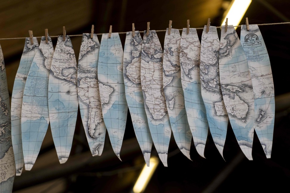 Hand-painted cartography on oval-shaped strips called “gores” drying in the workshop. Photo: AFP
