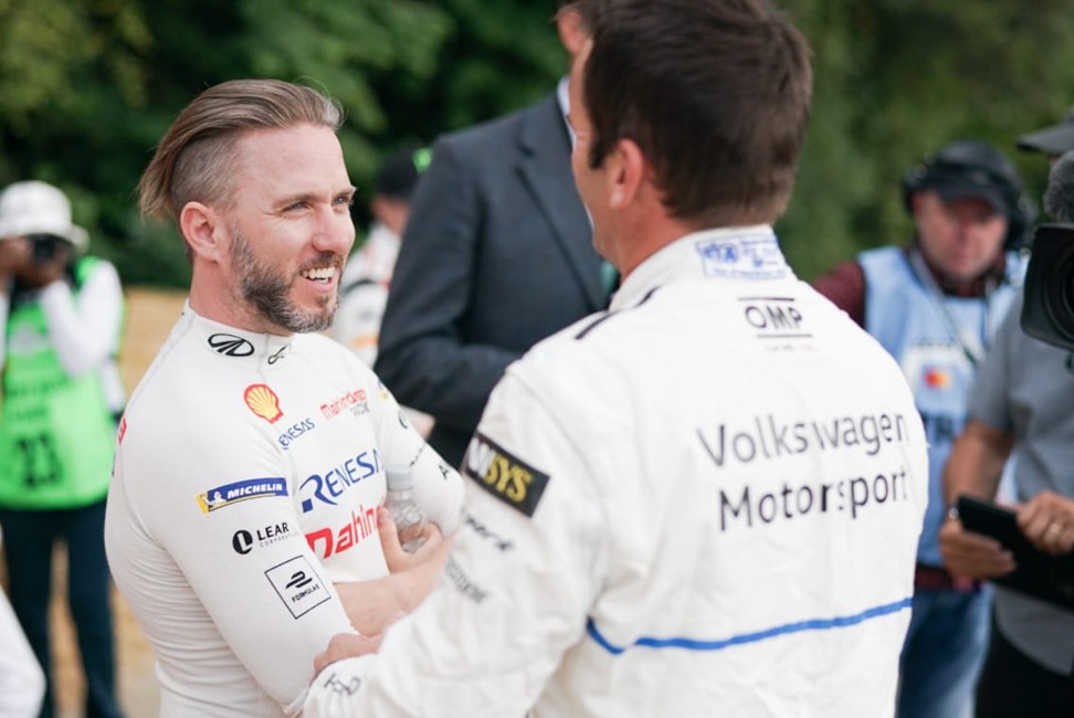 German racing driver Nick Heidfeld (left), the former record-holder over the Goodwood Festival of Speed hill climb course, chats to Romain Dumas, who now holds the record, at this year’s event in England.
