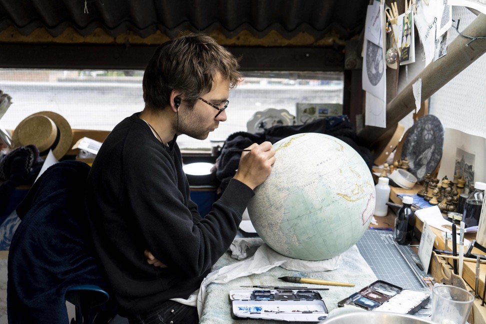 Two dozen illustrators, painters, cartographers, constructors, engravers and woodworkers work in the studio. Photo: AFP