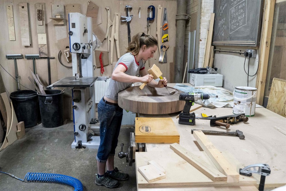 A woodworker preparing a base for a globe. Photo: AFP