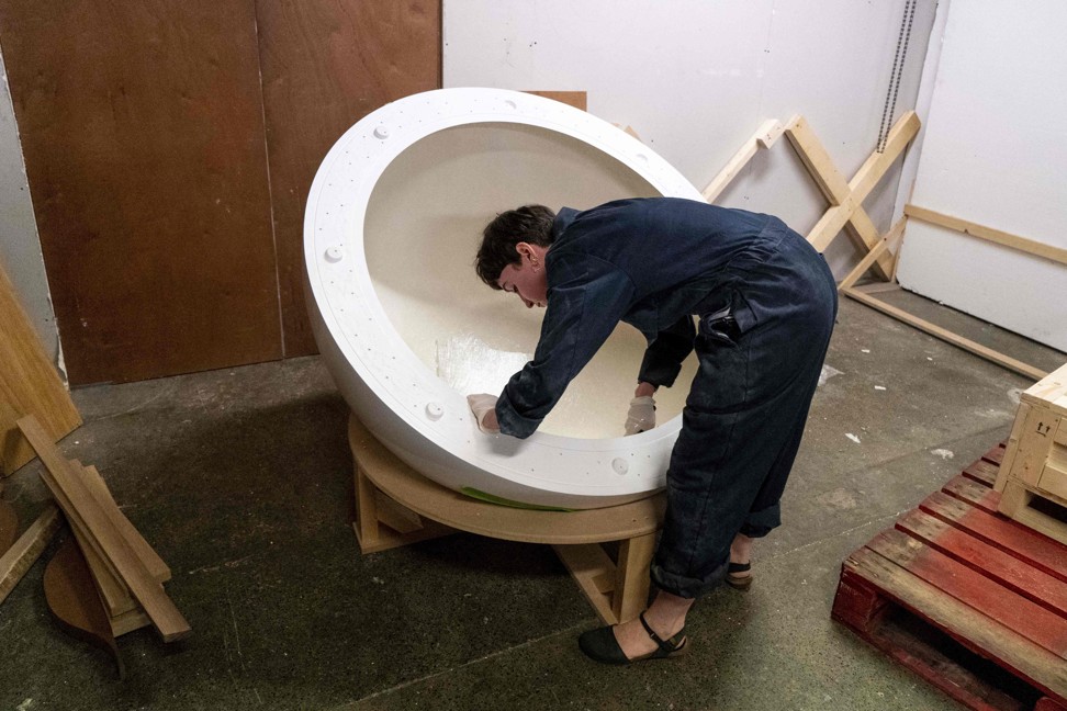 An artist preparing a glass-fibre cast at the workshop. Photo: AFP