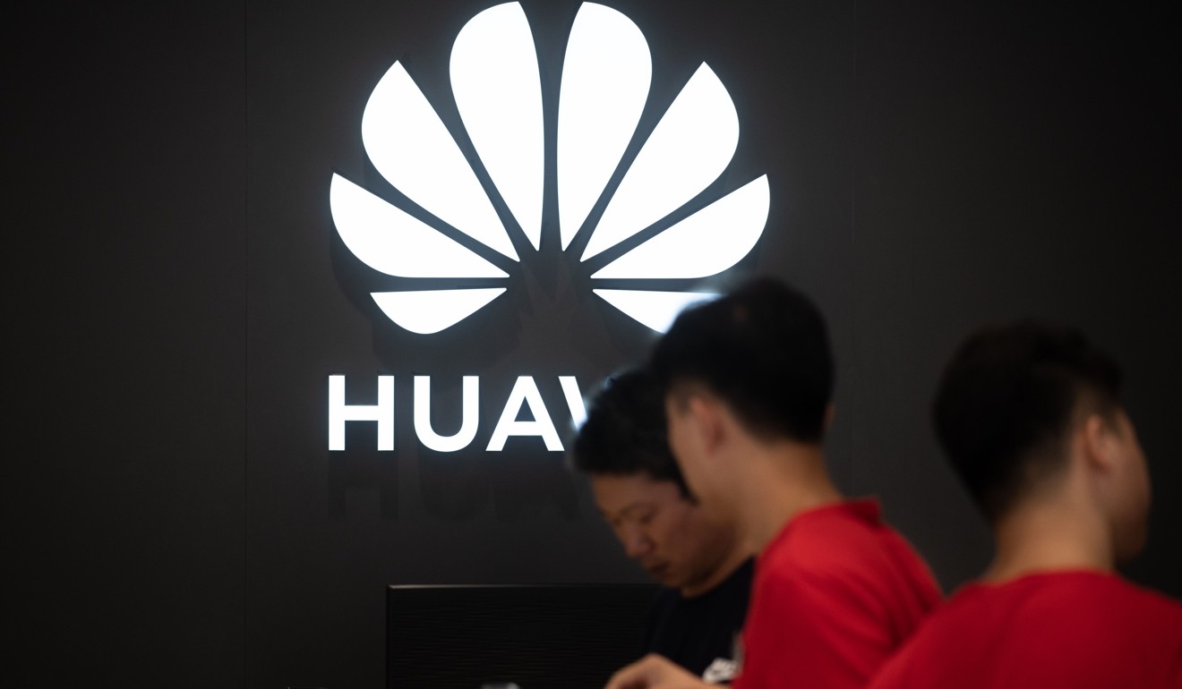 Employees work at a Huawei store in Dongguan, Guangdong province. Photo: AFP