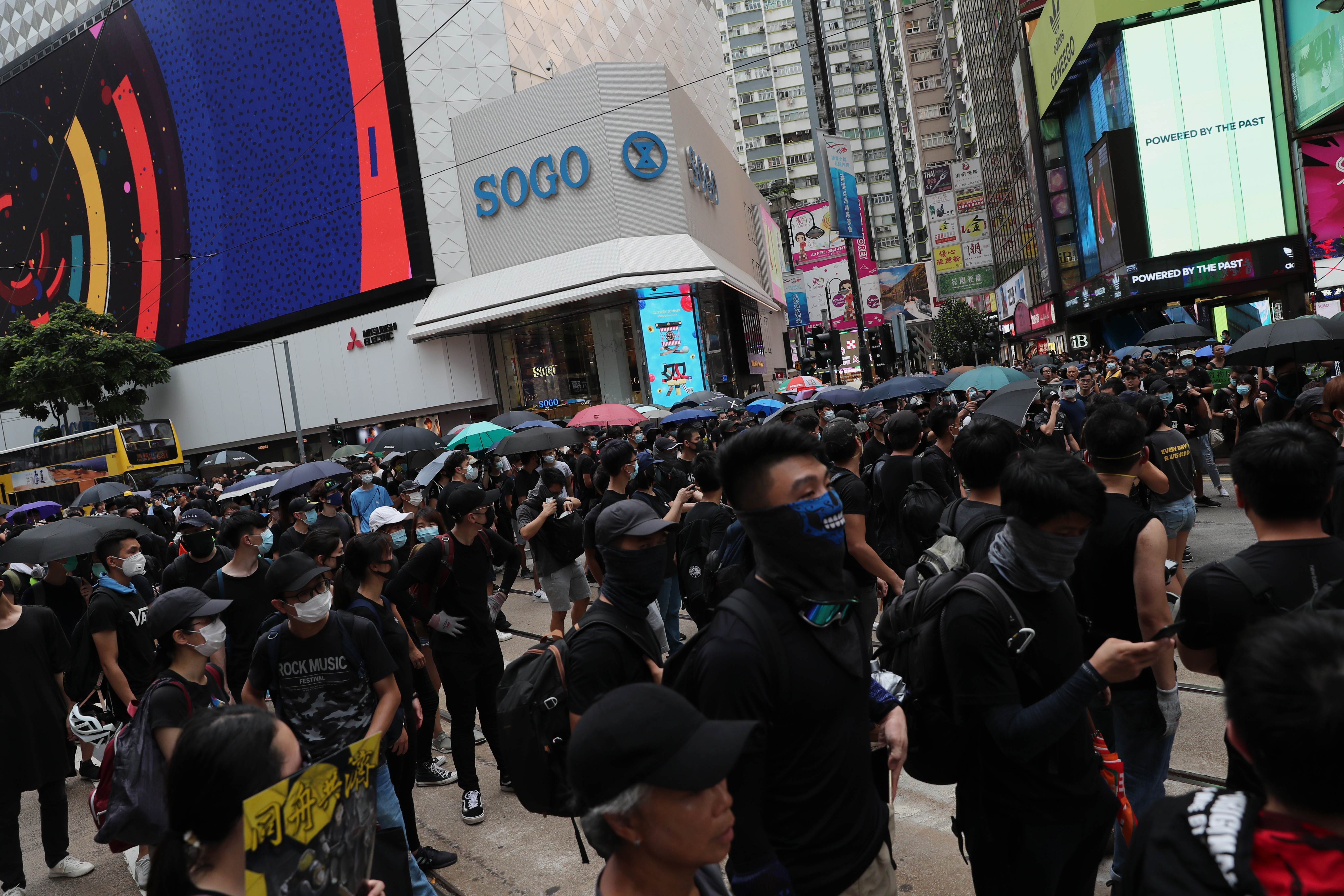 Anti-government protesters outside Sogo department store’s Causeway Bay branch on Sunday. Such protests since early June have led to fewer people visiting the store and a consequent drop in sales. Photo: Sam Tsang