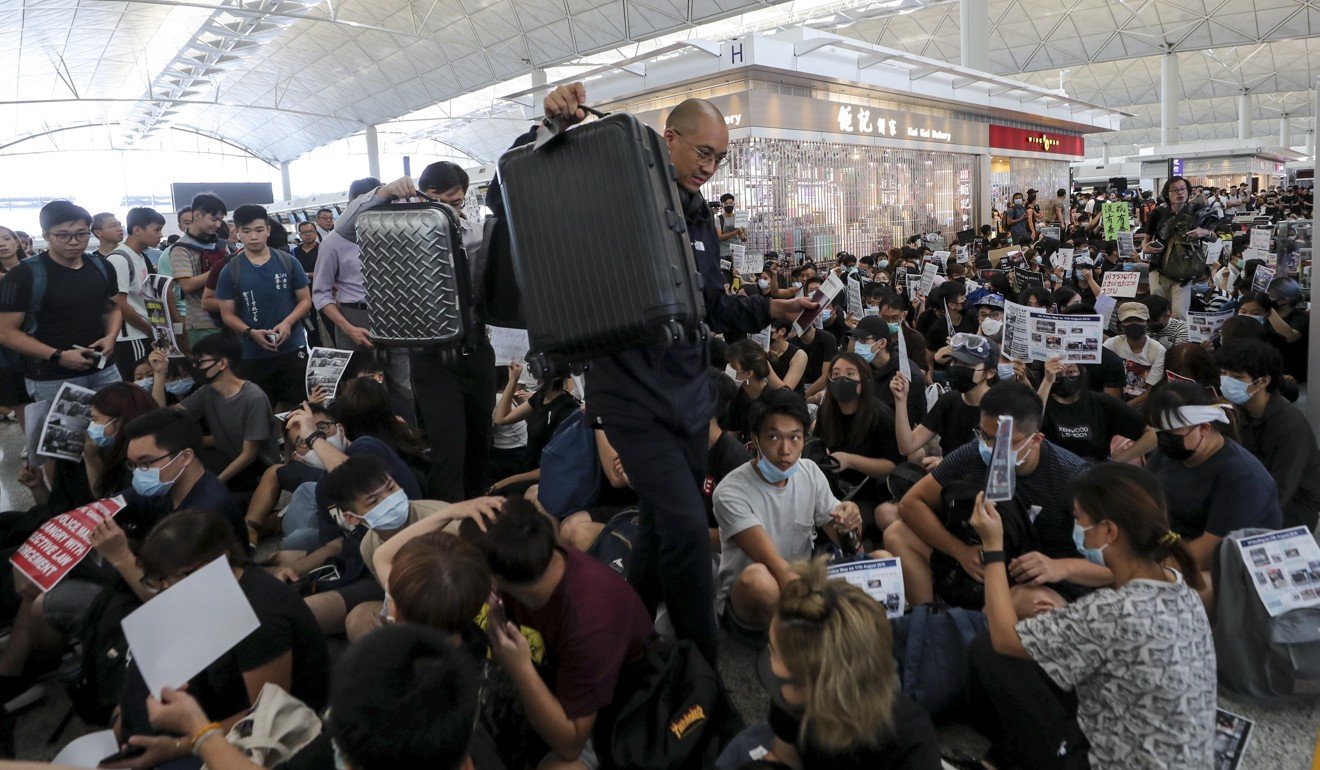 Protesters have gathered in their hundreds at Hong Kong airport’s departures, as travellers try to catch their flights. Photo: Sam Tsang