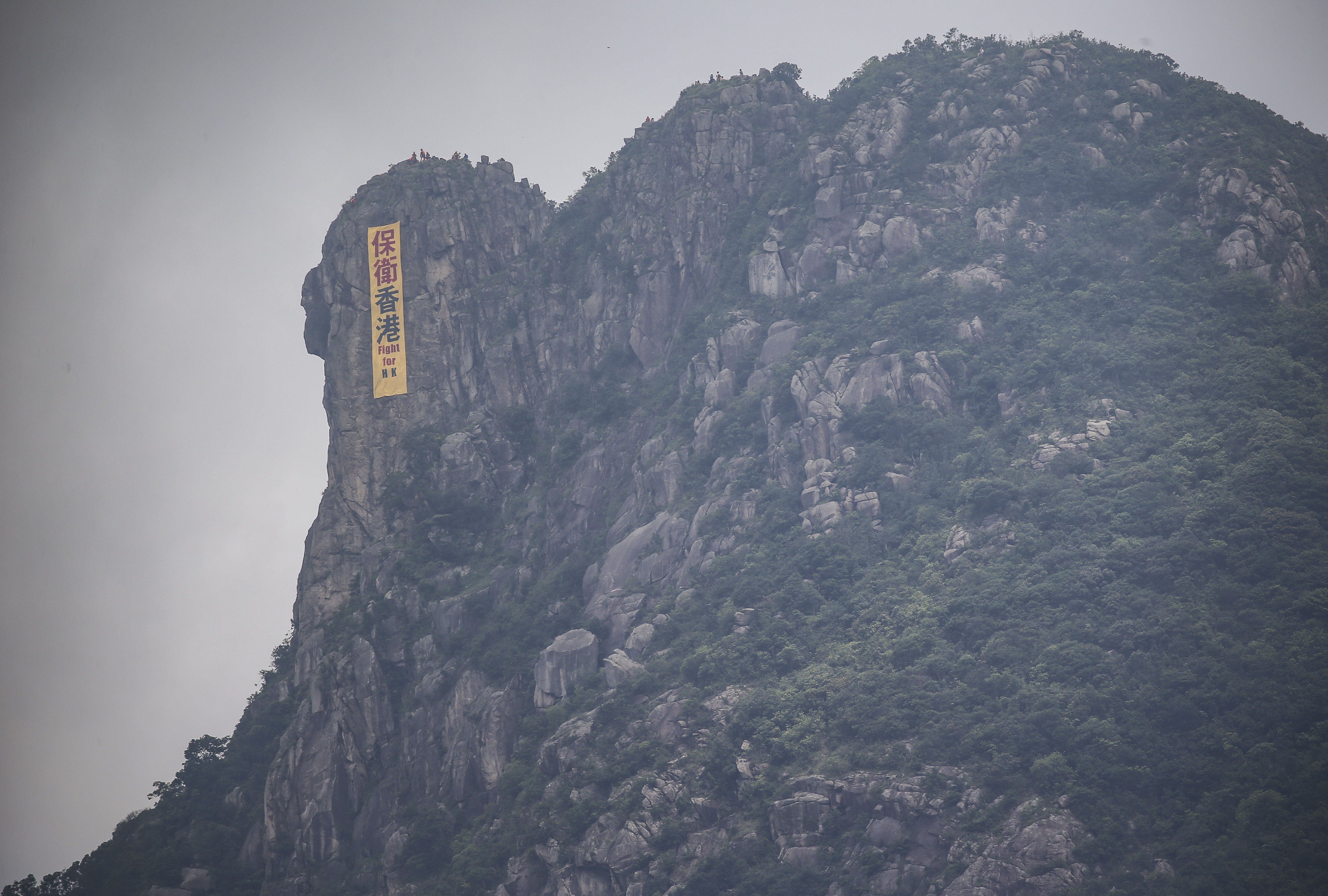 Fight for Hong Kong, says a banner seen hanging off Lion Rock in June. Photo: Winson Wong