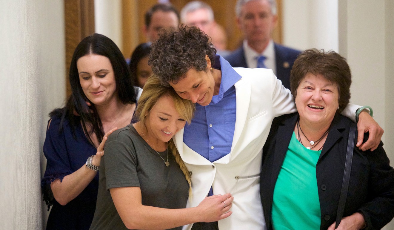Andrea Constand (centre) and supporters embrace after Cosby’s conviction last year. Photo: AP