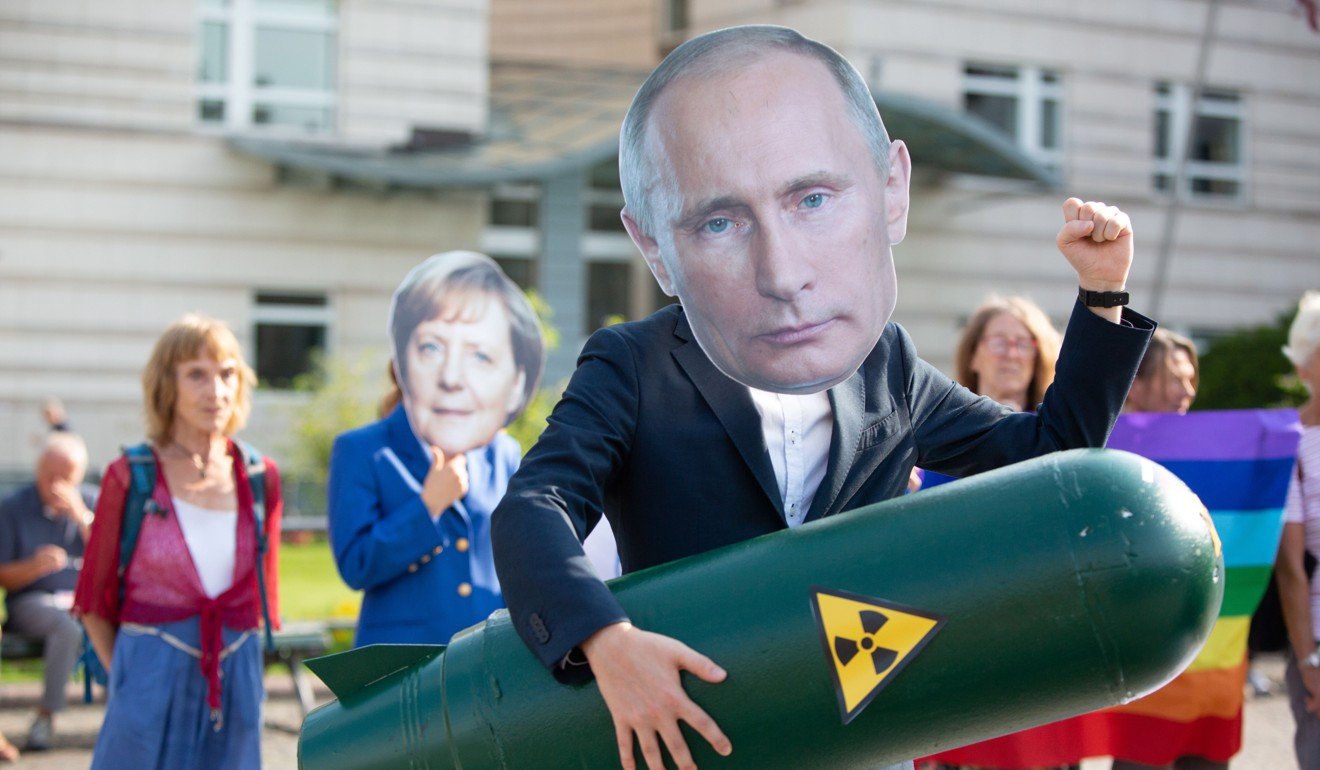 A German activist wears a Vladimir Putin mask as he holds a mock missile during a demonstration against the ending of the Intermediate-Range Nuclear Forces Treaty in front of the American Embassy in Berlin. Photo: EPA-EFE