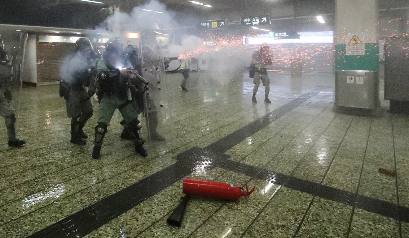 Riot police fire tear gas in Kwai Fong MTR station. Photo: Felix Wong