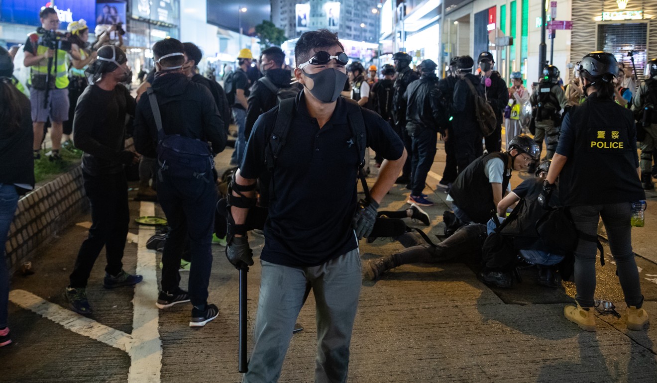 Men believed to be police officers dressed as protesters detain demonstrators on Hennessy Road. Photo: Kyle Lam/Bloomberg