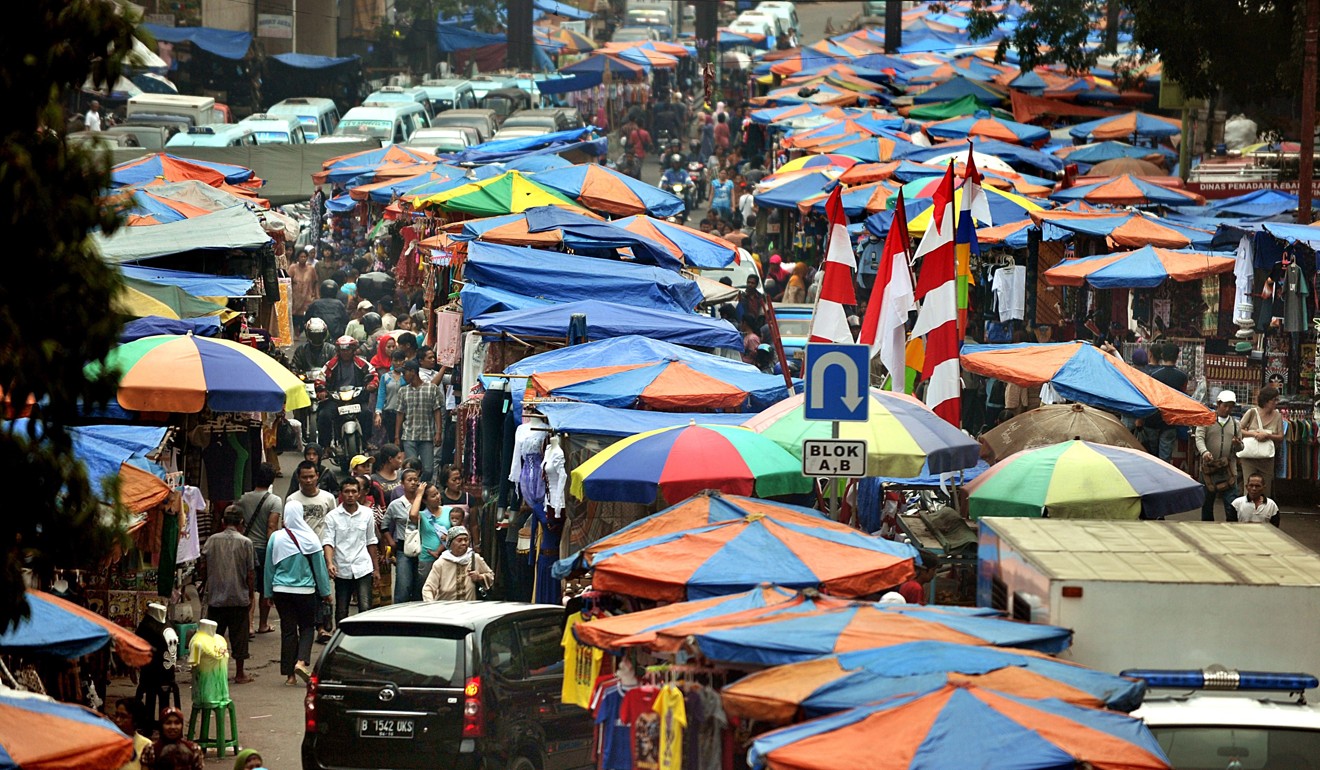Residents of Jakarta walk around a busy market street in the Indonesian capital. Photo: AFP