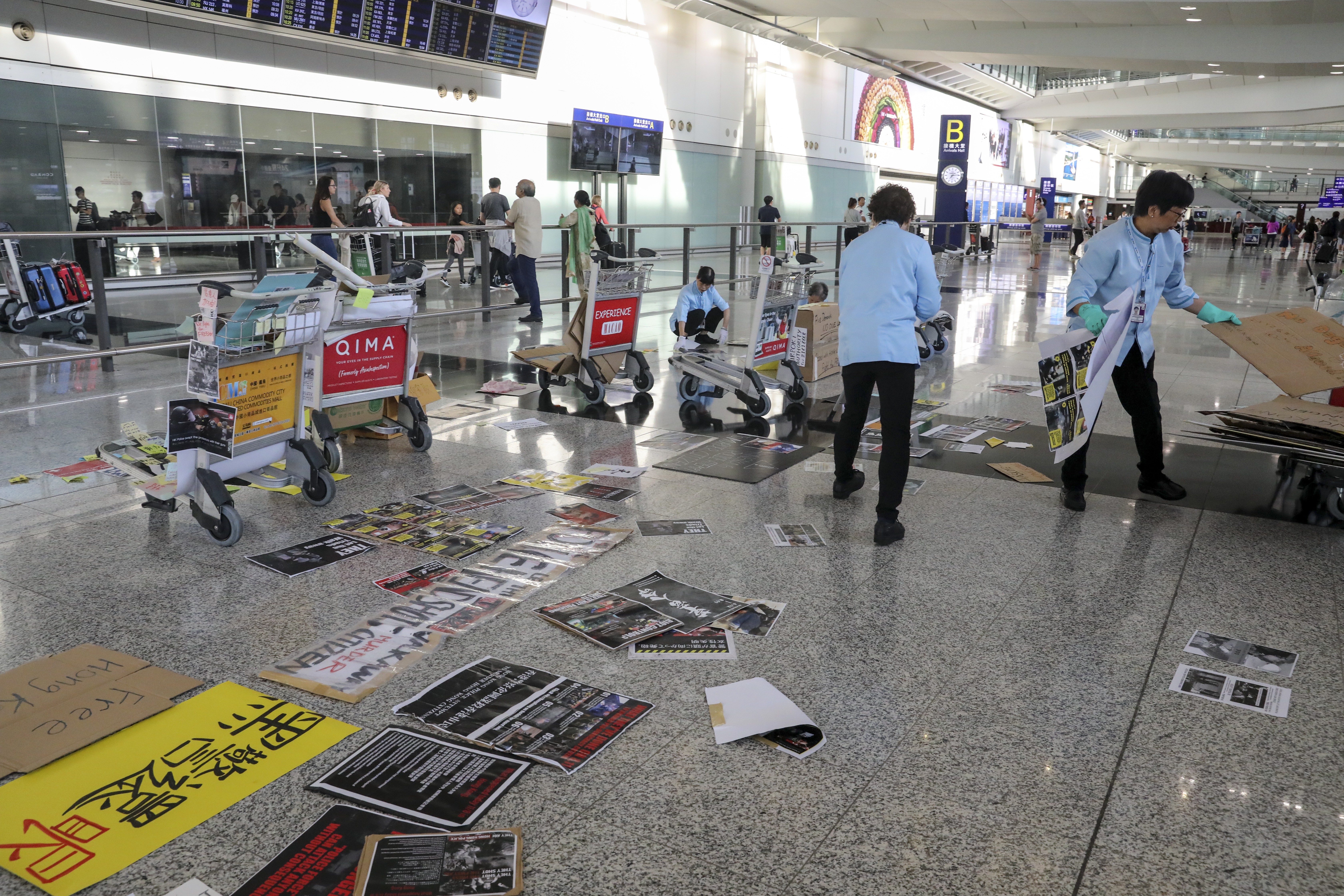 Cleaners remove what remains of the protest paraphernalia at the airport. Photo: Dickson Lee