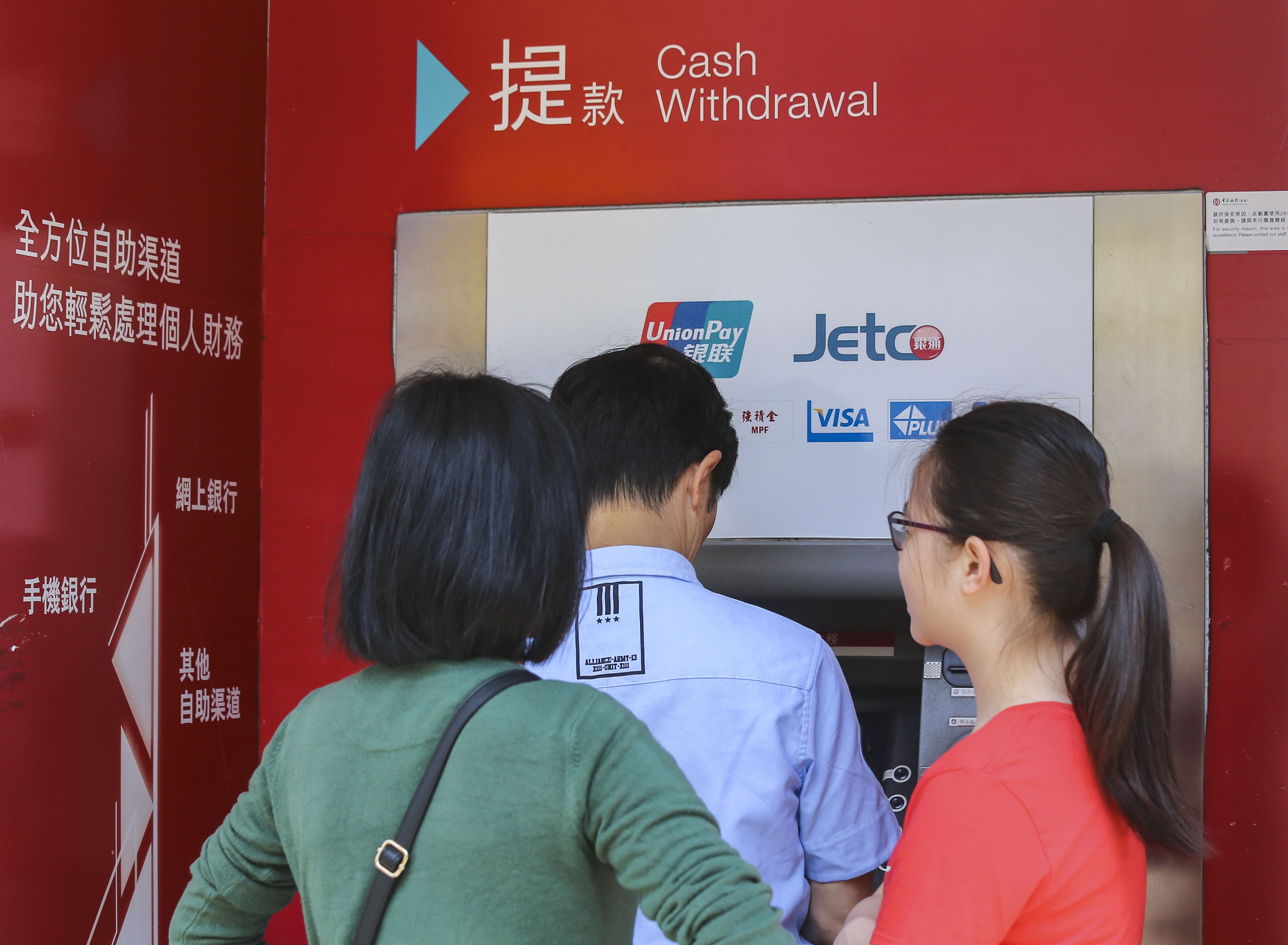 Customers using a Bank of China (Hong Kong) automated teller machine in Hong Kong on 31 March 2018. Photo: SCMP / Dickson Lee