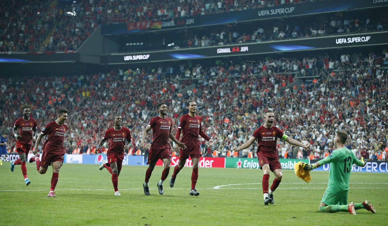 Liverpool players run to celebrate with Adrian after their penalty shoot-out triumph. Photo: AP