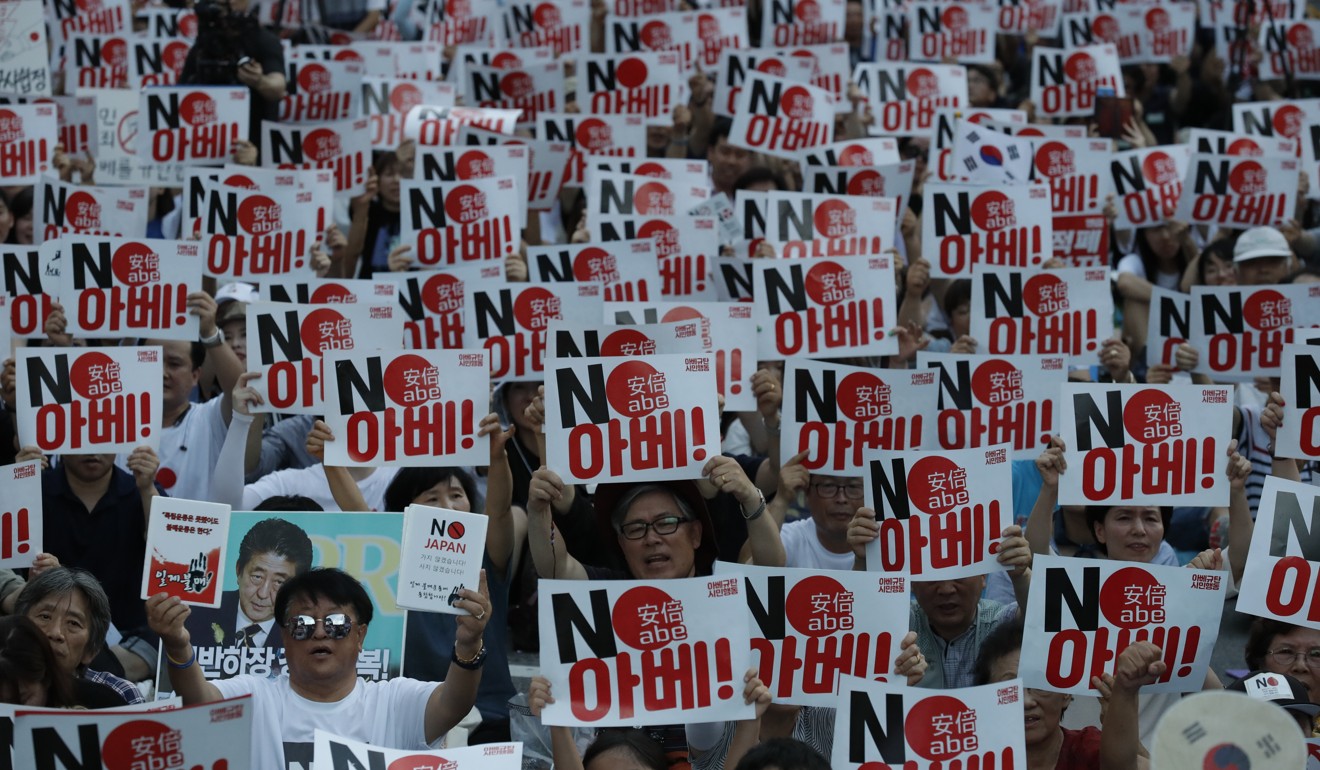 South Korean protesters holding signs that read “No Abe” denounce Japan’s prime minister and call for the South Korean government to abolish the General Security of Military Information Agreement, an intelligence-sharing agreement between South Korea and Japan, near the Japanese embassy in Seoul on August 10. Photo: AP