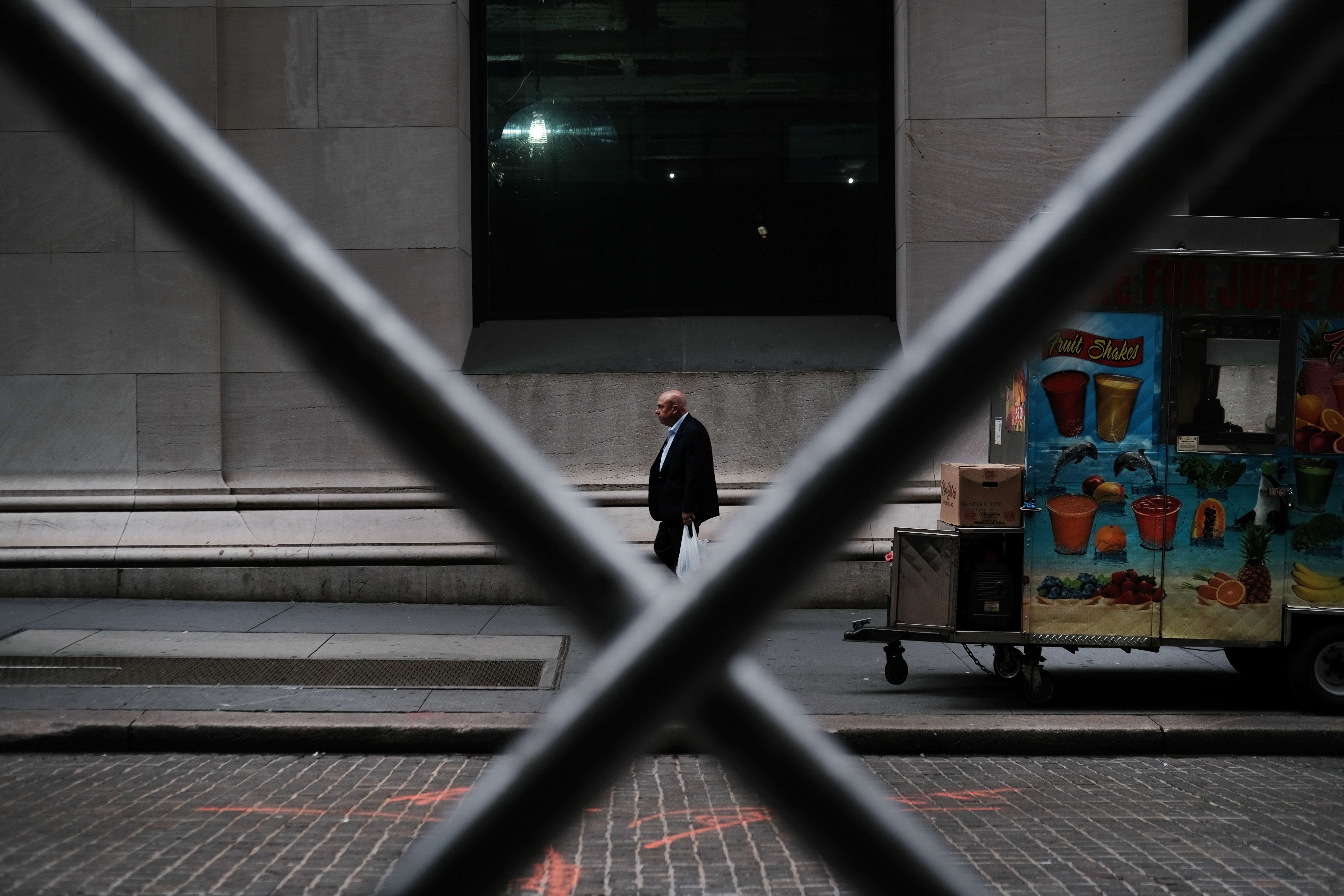 A man walks by the New York Stock Exchange on August 14. Concerns over a recession have sent stocks plummeting. Photo: AFP