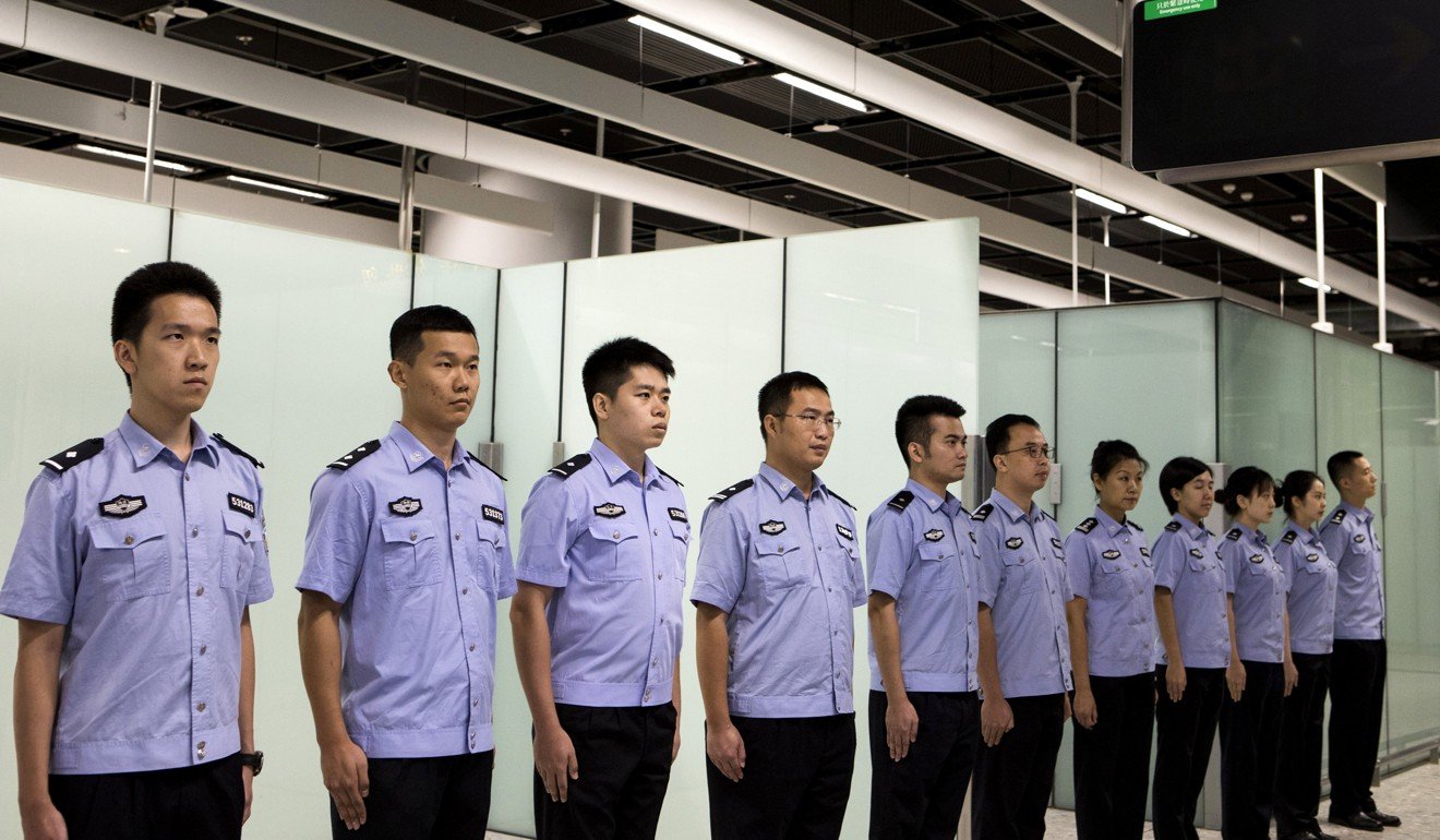Immigration officers stand in formation in the Mainland Port Area at West Kowloon Station in 2018. Photo: Reuters