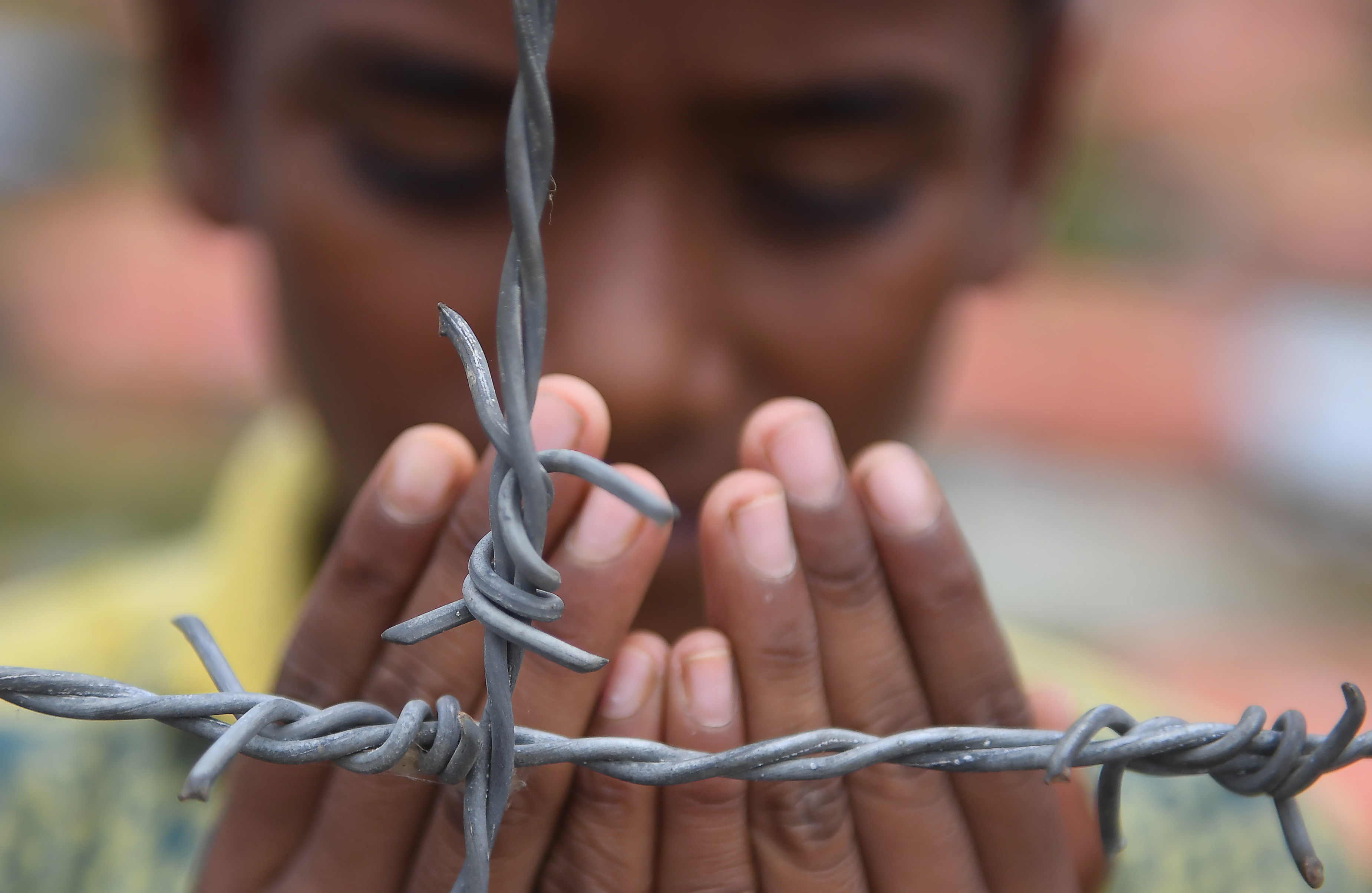 A Rohingya at a refugee camp prays in remembrance on the first anniversary of a military crackdown that prompted a massive exodus of people from Myanmar to Bangladesh. Photo: AFP