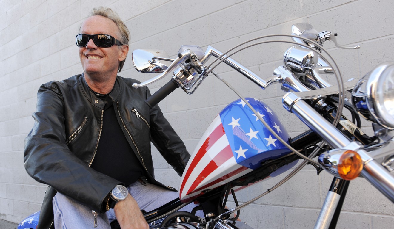 Fonda poses atop a replica of his “Captain America” bike from the film ‘Easy Rider’ in 2009. Photo: AP