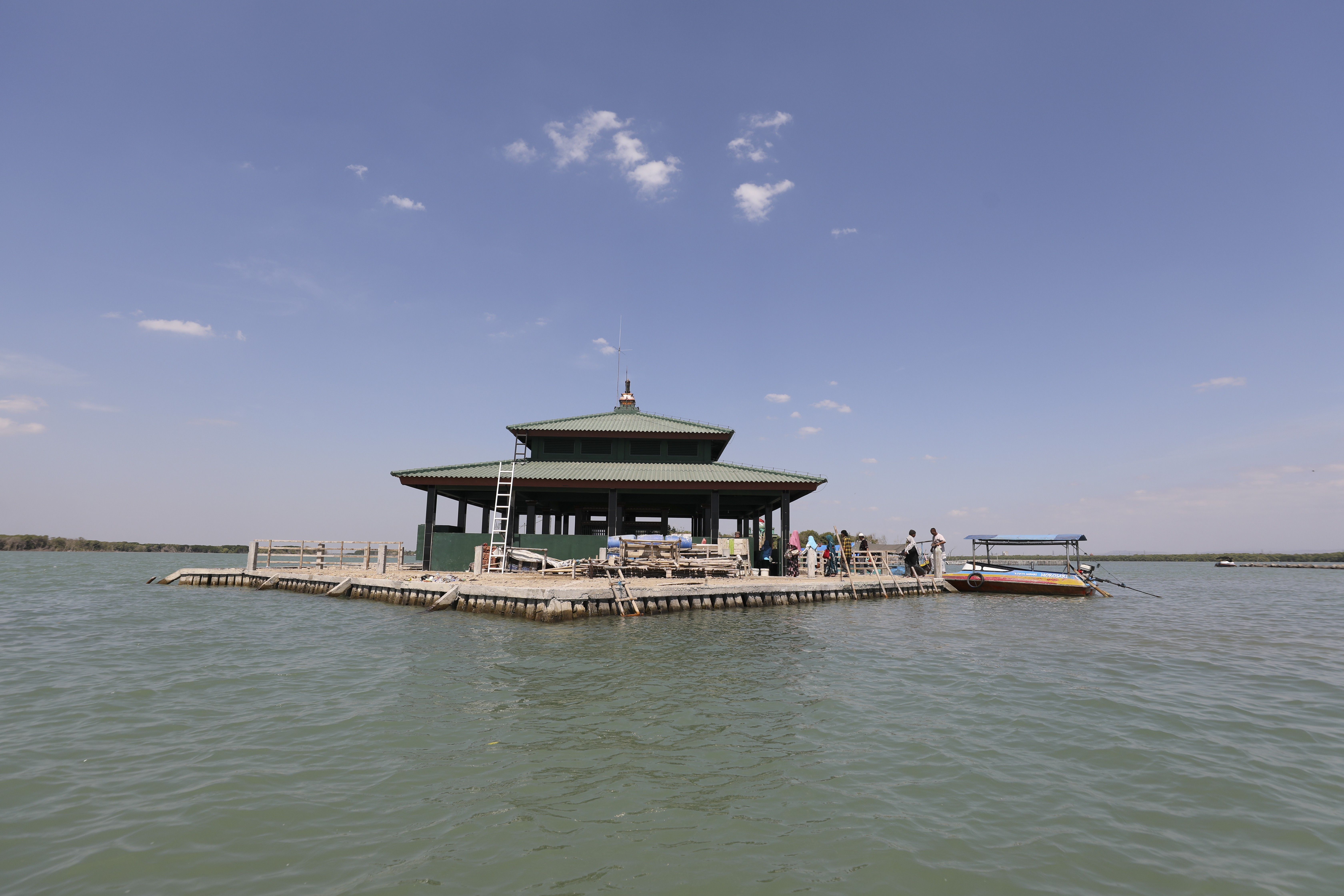 Muslim pilgrims (R) visit the tomb of Syeh Abdullah Mudzakir, in the village of Bedono, Semarang, an eco-tourism area that is slowing "sinking" on the north coast of the island of Java, Indonesia on August 06, 2019. Mudzakir's tomb and several nearby did not sink along with other tombs, so people think there was a supernatural reason behind that phenomenon. 06AUG19 [TRAVEL FEATURES] SCMP / Antony DICKSON