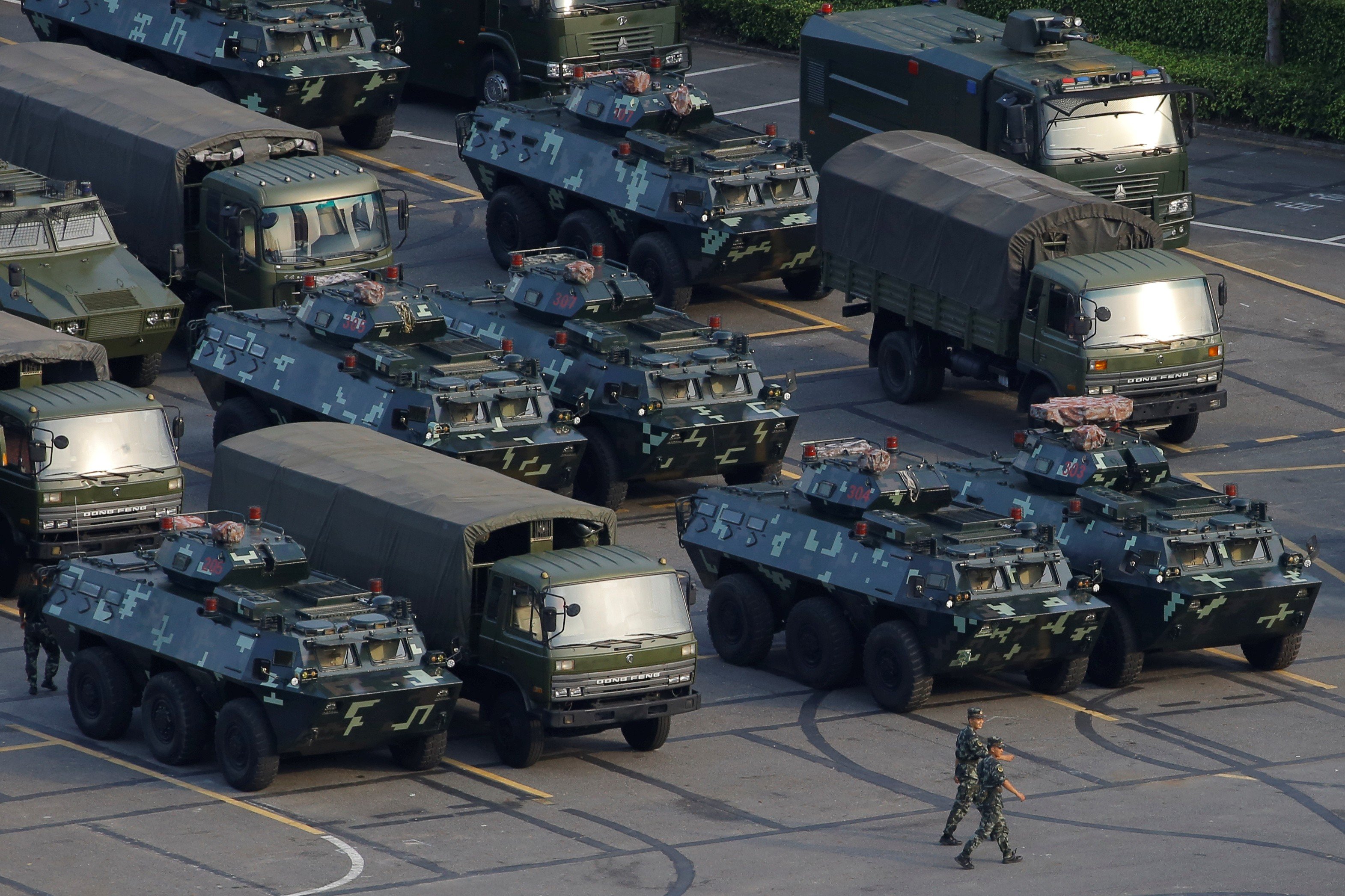 Military vehicles parked on the grounds of the Shenzhen Bay Sports Centre in Shenzhen. Photo: Reuters