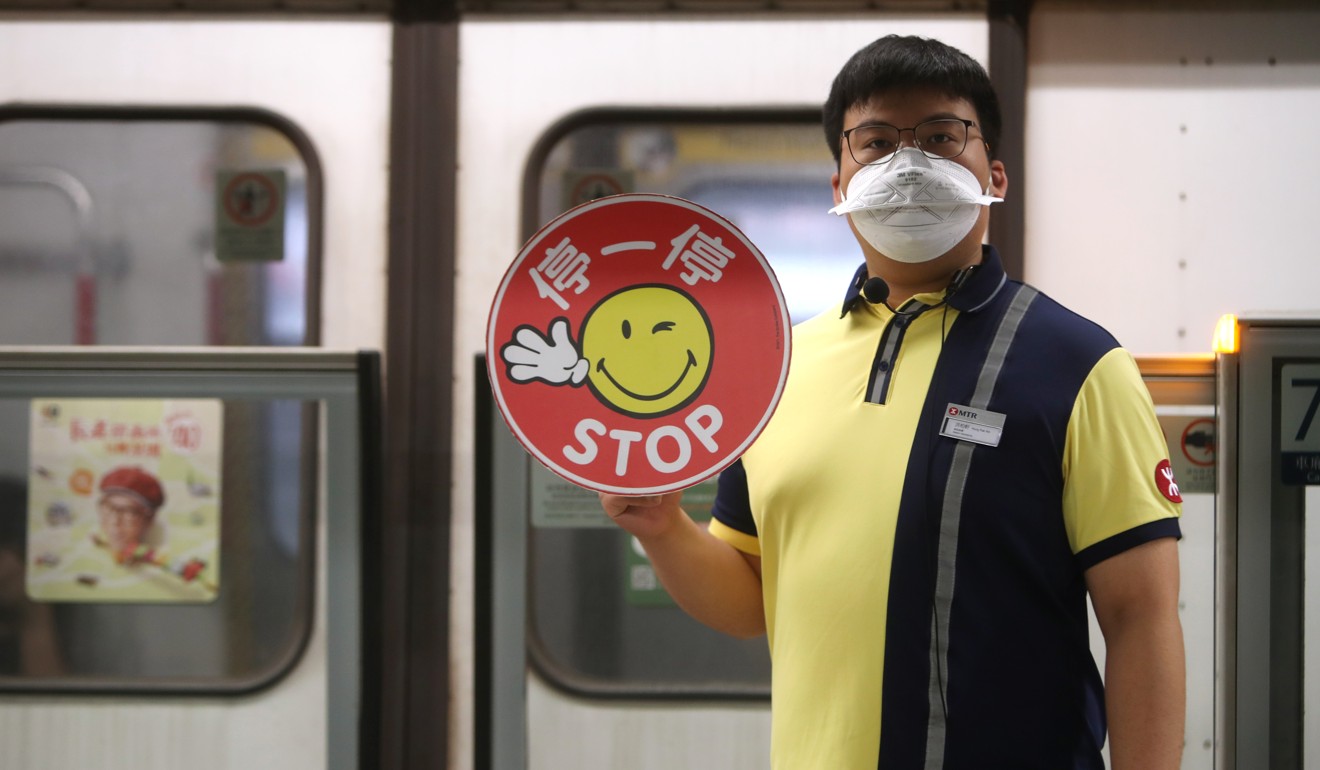 An MTR employee wears a protective mask to protect himself from tear gas at Kwai Fong station. Photo: Winson Wong
