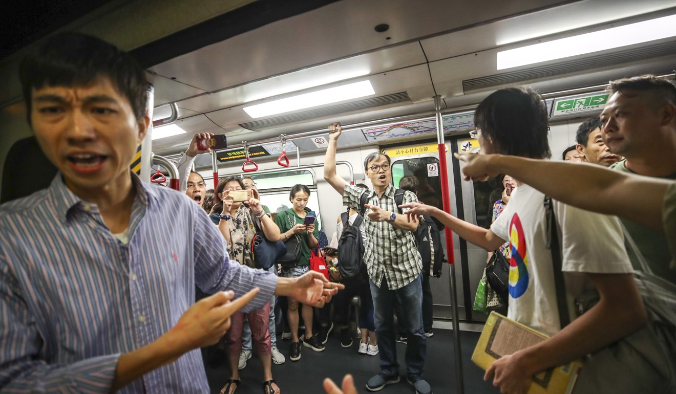 Commuters argue with anti-government protesters as they try to stop MTR services at Fortress Hill station on August 5. Photo: Winson Wong