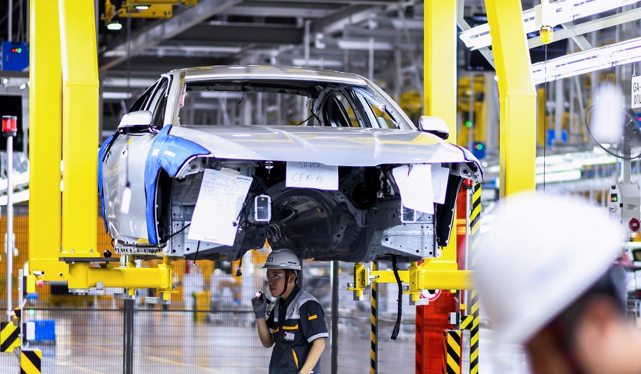 Workers operate the car assembly line at the new automobile plant of VinFast. Photo: AFP
