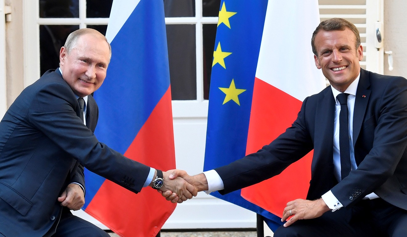 French President Emmanuel Macron (right) shakes hands with Russia's President Vladimir Putin at the Bregancon fortress in France on Monday. Photo: Reuters