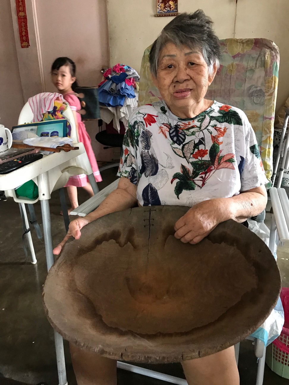 A villager showing an old item from her home. A team seeking to revive Kampung Cempaka has proposed setting up a community museum. Photo: Project Community Kampung Cempaka.