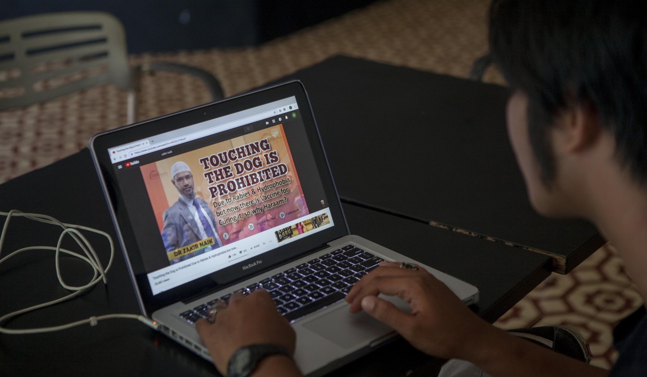 A man looks at a Zakir Naik video on YouTube in Jakarta in February. Photo: Agoes Rudianto