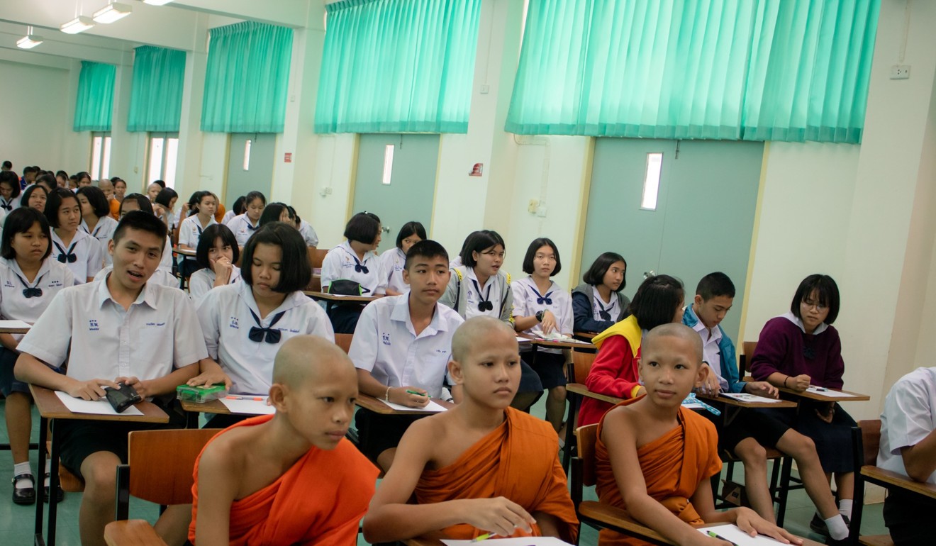 Novice monks alongside other competitors in the KKU Nong Khai Fair for e-sports.