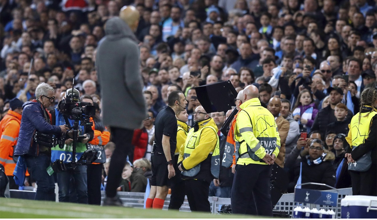 Referee Cuneyt Cakir consults VAR as Manchester City manager Pep Guardiola looks on before awarding Tottenham Hotspur their third goal in last season’s Champions League quarter-final. Photo: AP