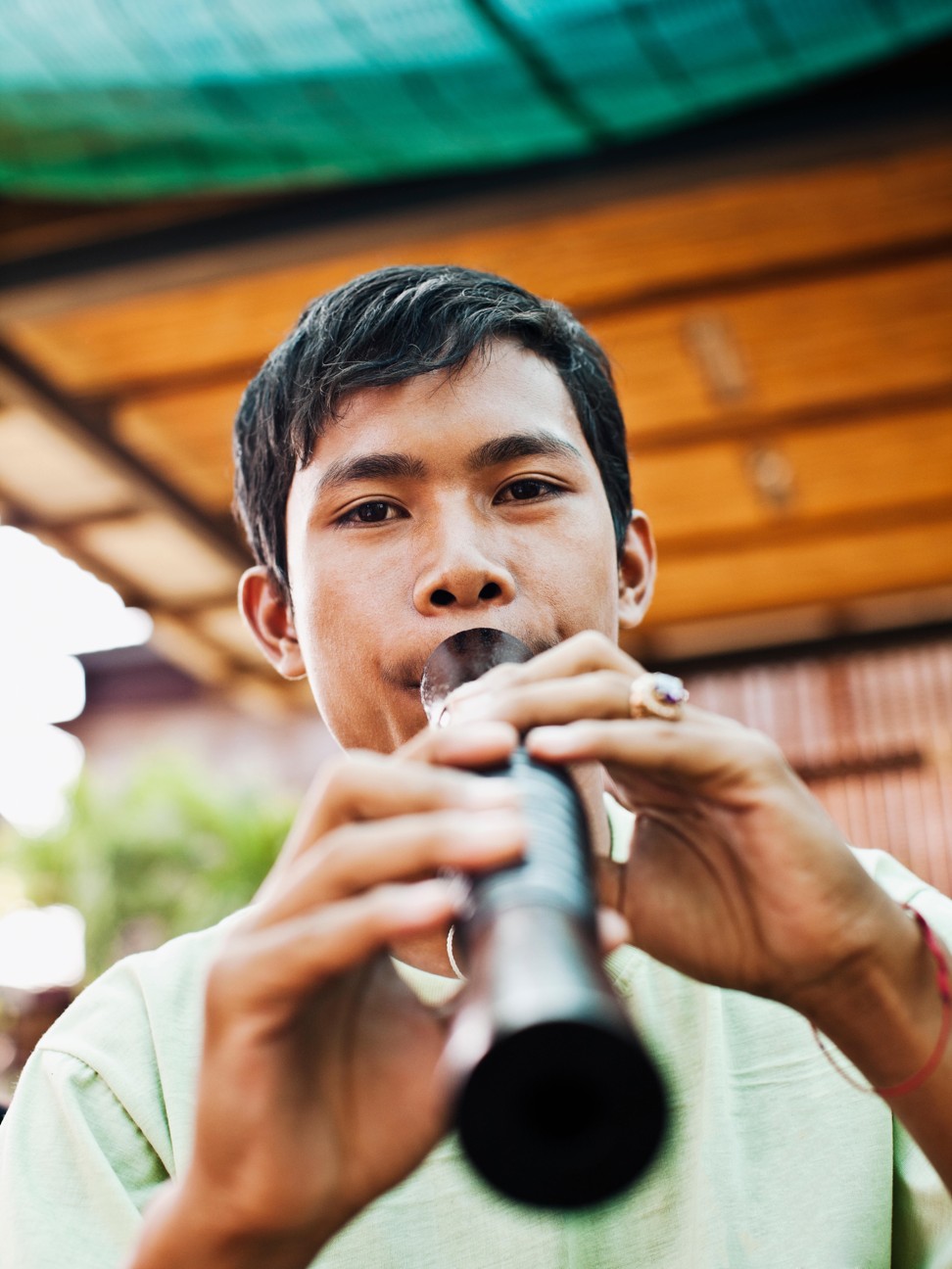 CLA student Yim Sokung playing a sralai, a Cambodian wind instrument. Photo: Alamy