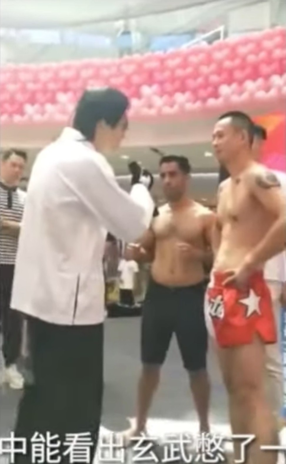 Tan Long trash talks Xuan Wu at the weigh-in.