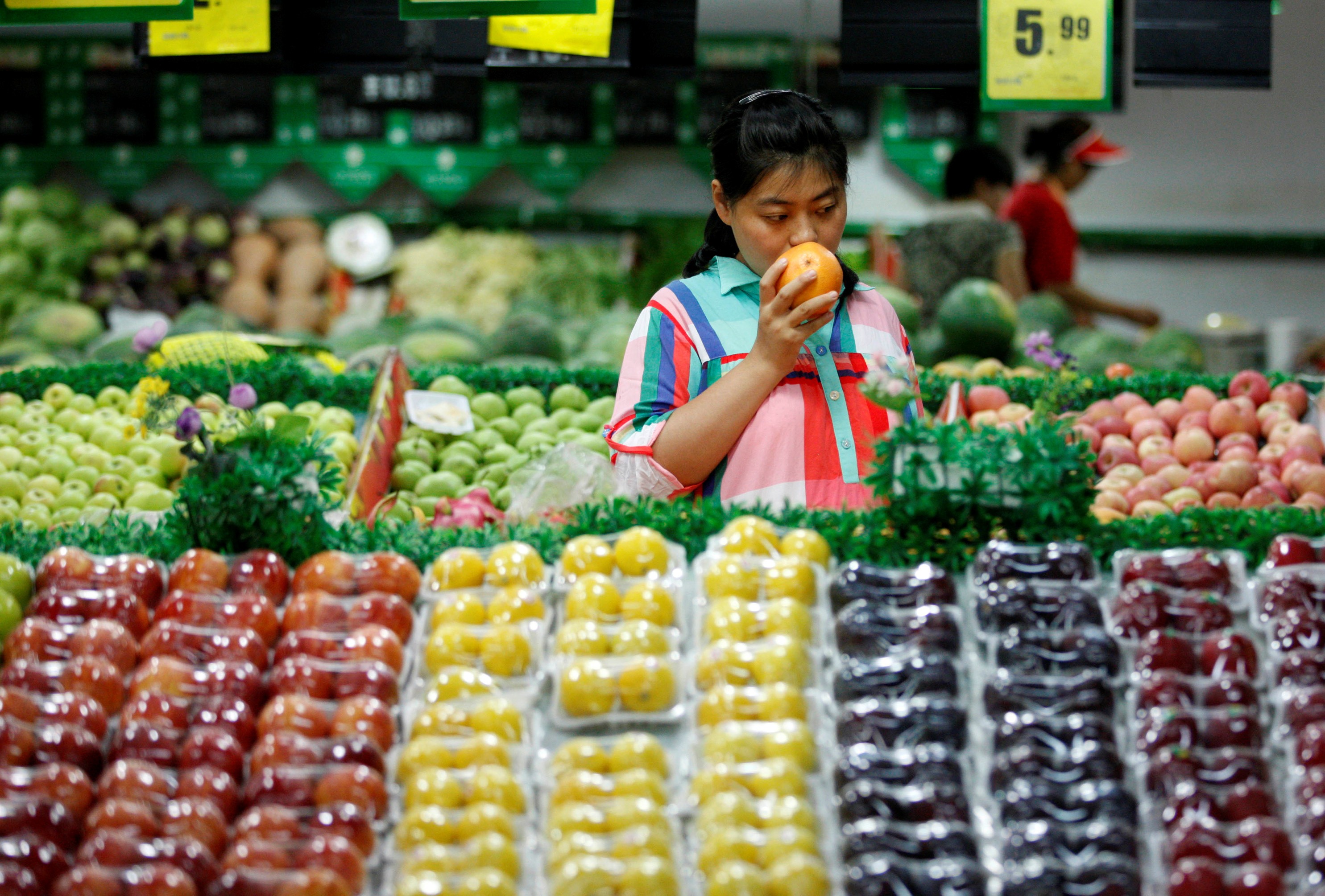 A woman chooses fruit at a supermarket in Huaibei, in China’s Anhui province. China, already at the upper range of middle-income economies, is expected to break into the “high-income” category by 2023. Photo: Reuters