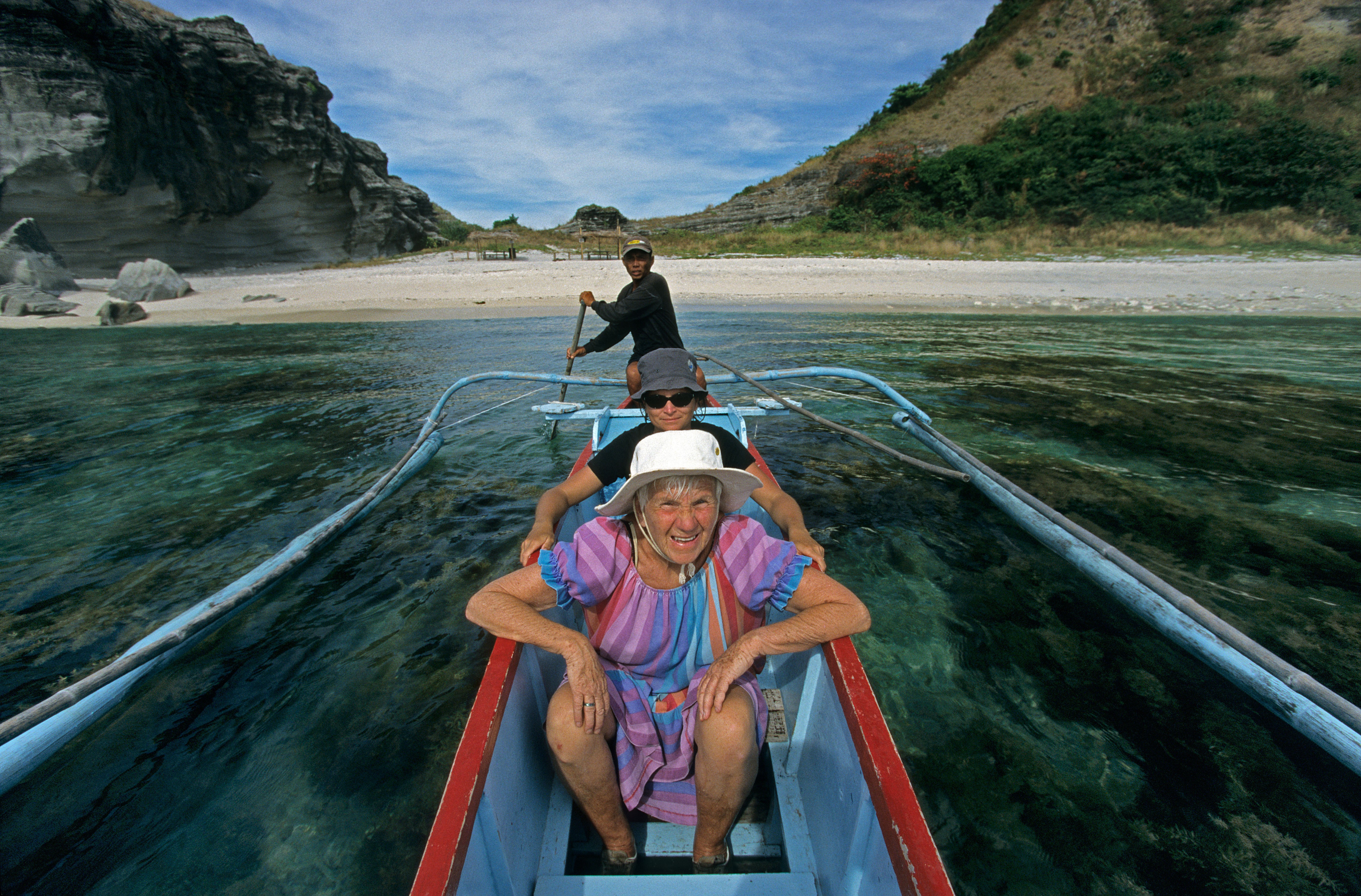 A pensioner enjoys a day on an outrigger boat in the Philippines. Low living costs, cheap domestic travel, and lifetime non-immigrant visas are among the attractions of retiring in the country. Photo: Alamy