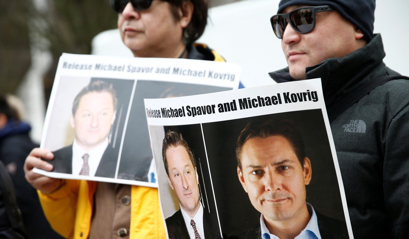 People hold signs calling for China to release Canadian detainees Michael Spavor and Michael Kovrig during an extradition hearing for Huawei Technologies Chief Financial Officer Meng Wanzhou in Vancouver, British Columbia on March 6. Photo: Reuters