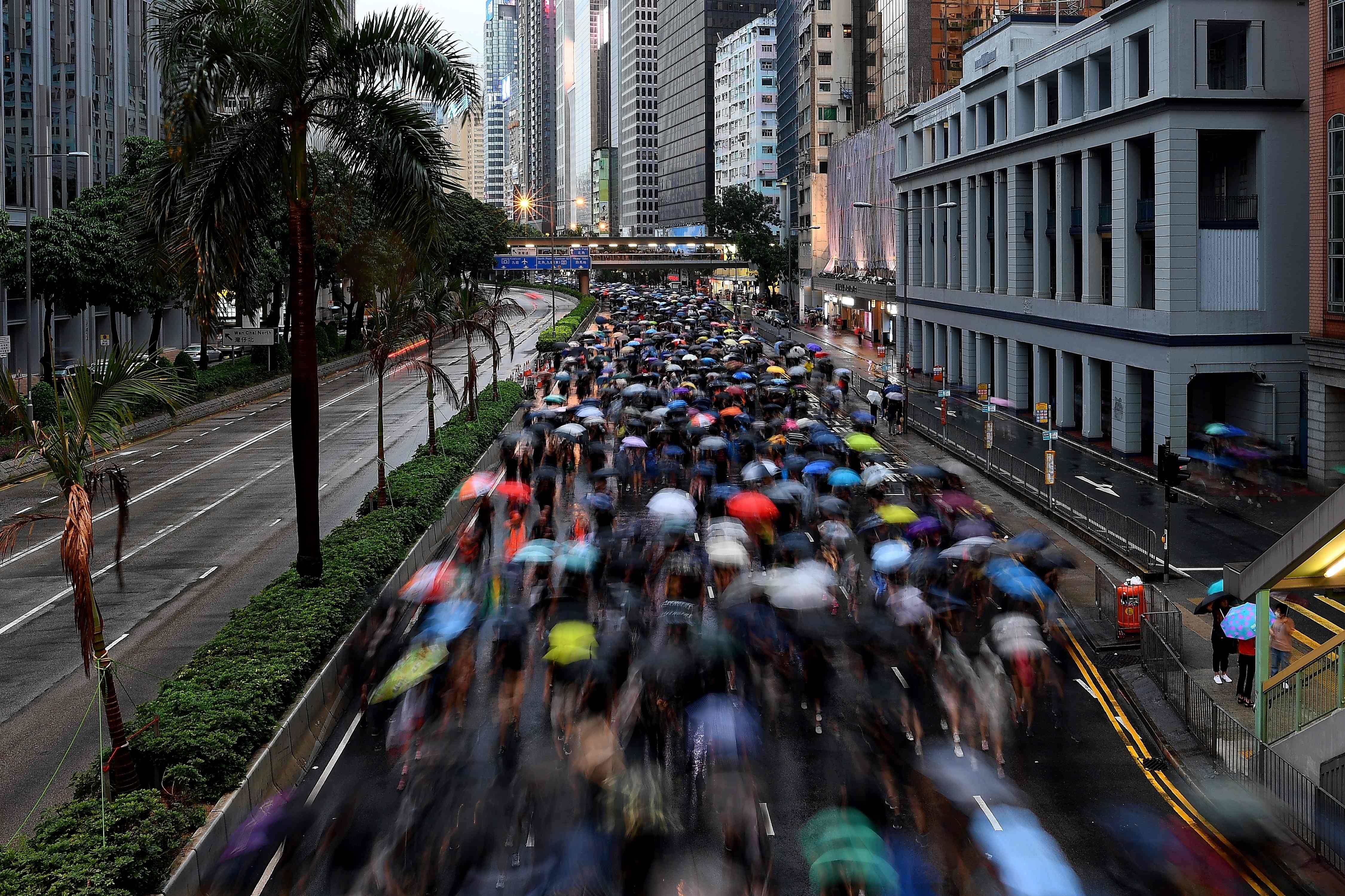 Protesters on the march during a rally in Hong Kong on August 18. The water represented by a Pig year could have been a boon for Hong Kong, a Wood Dragon, but there is such a thing as too much water. Photo: AFP
